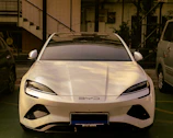 A white sports car parked in a parking lot