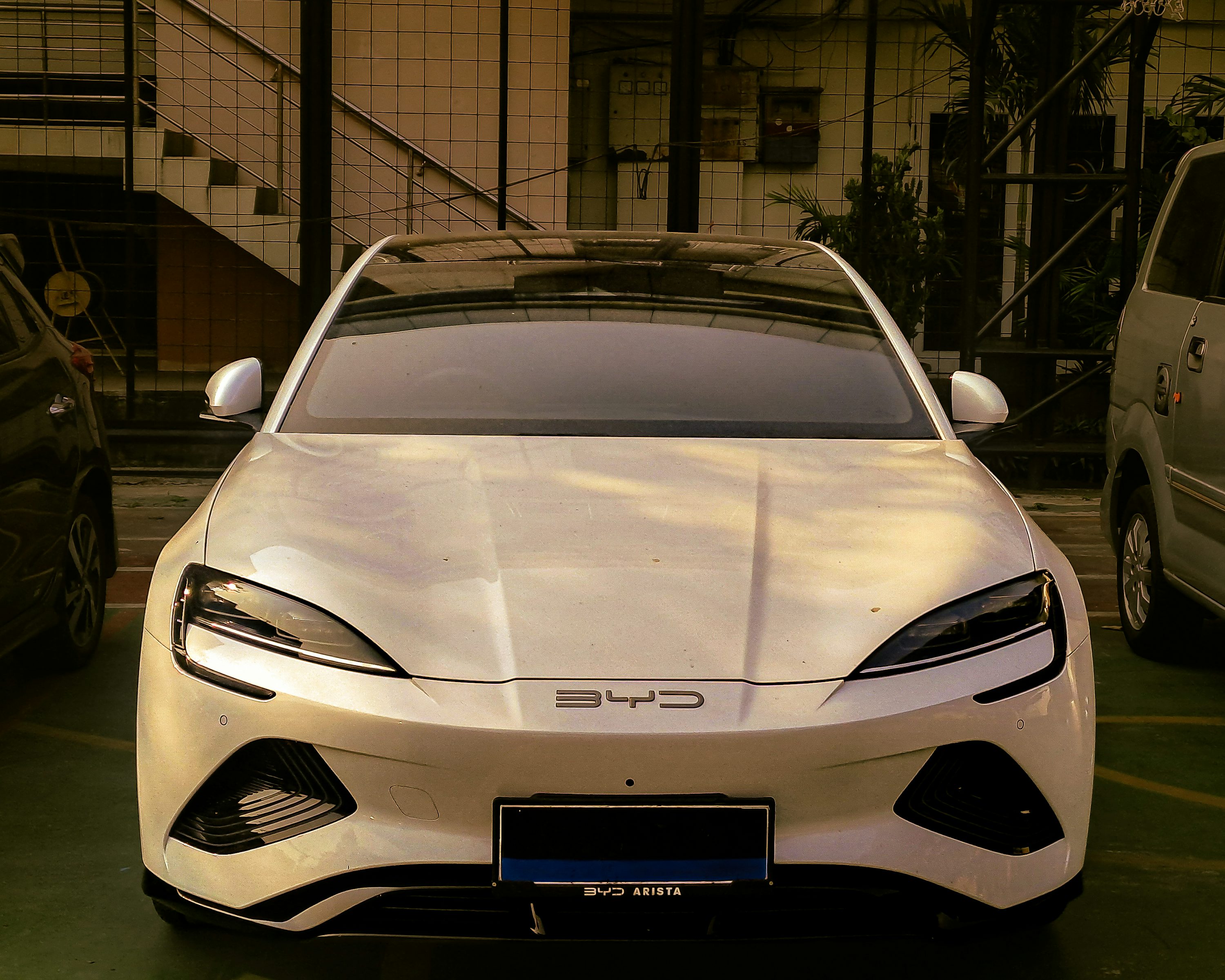 A white sports car parked in a parking lot