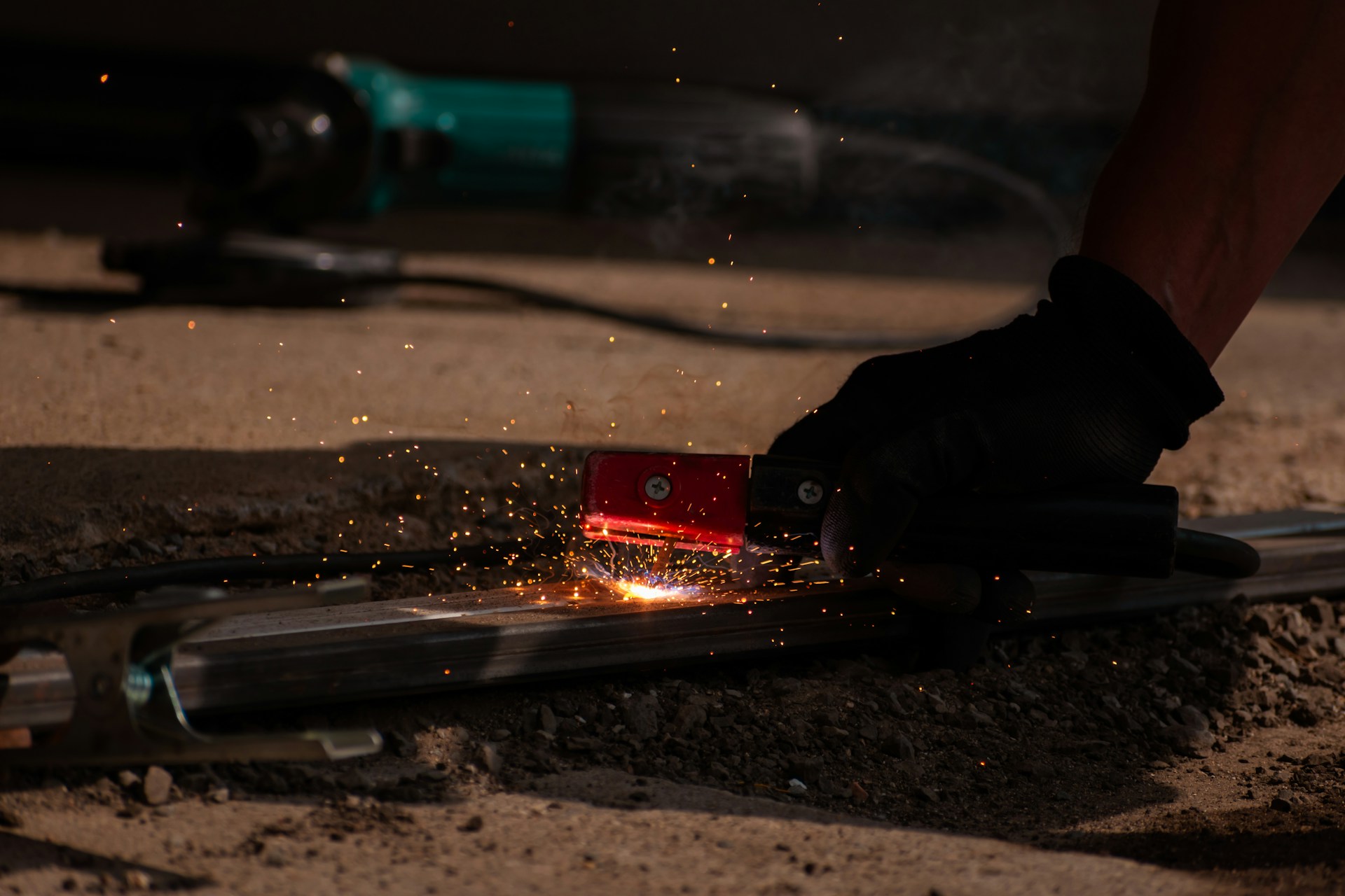 A person is working on a piece of metal