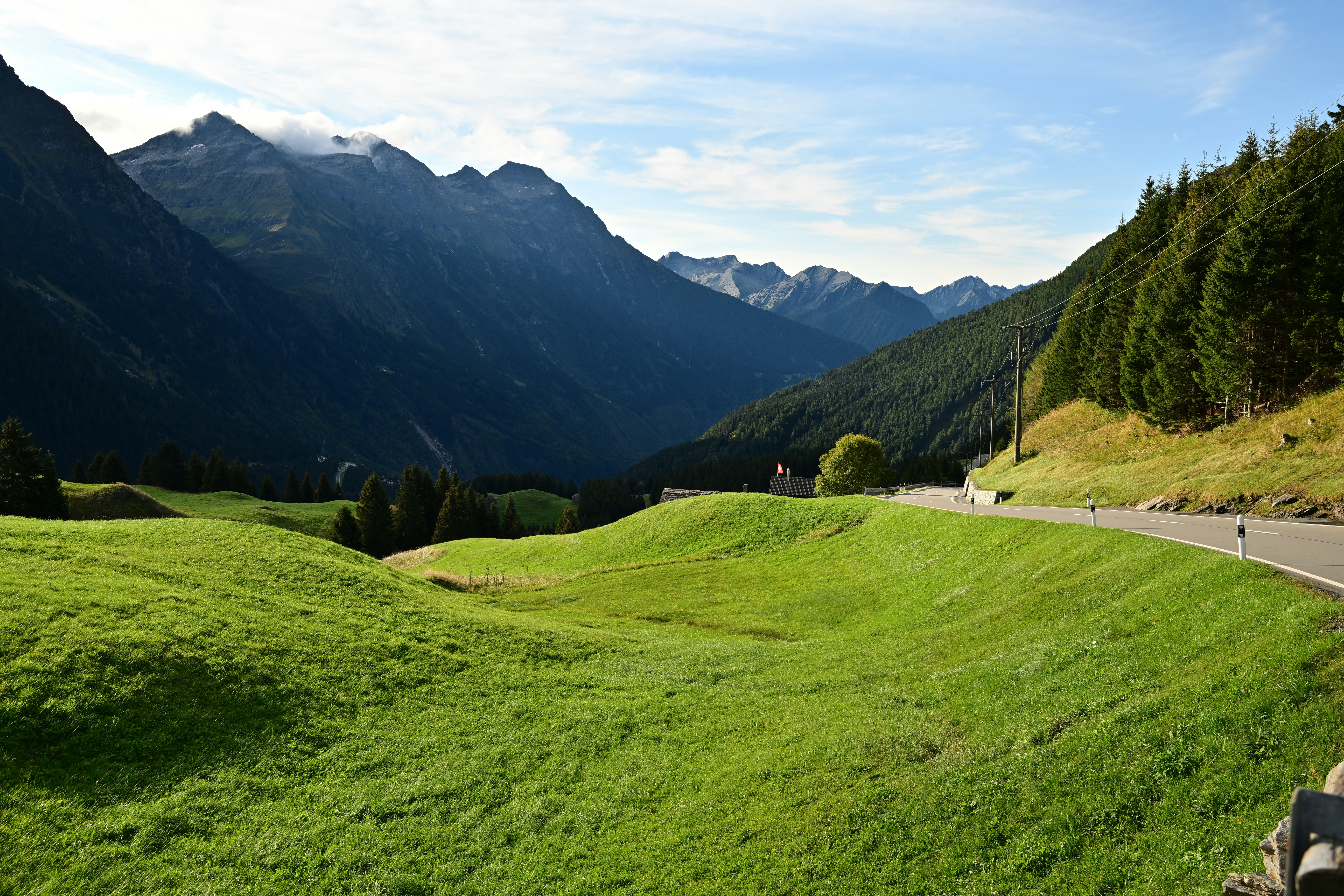 A person riding a bike on a road in the mountains