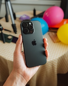 A person holding an iPhone 16 pro in their hand