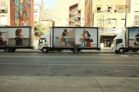 A line of delivery trucks parked on the side of the road