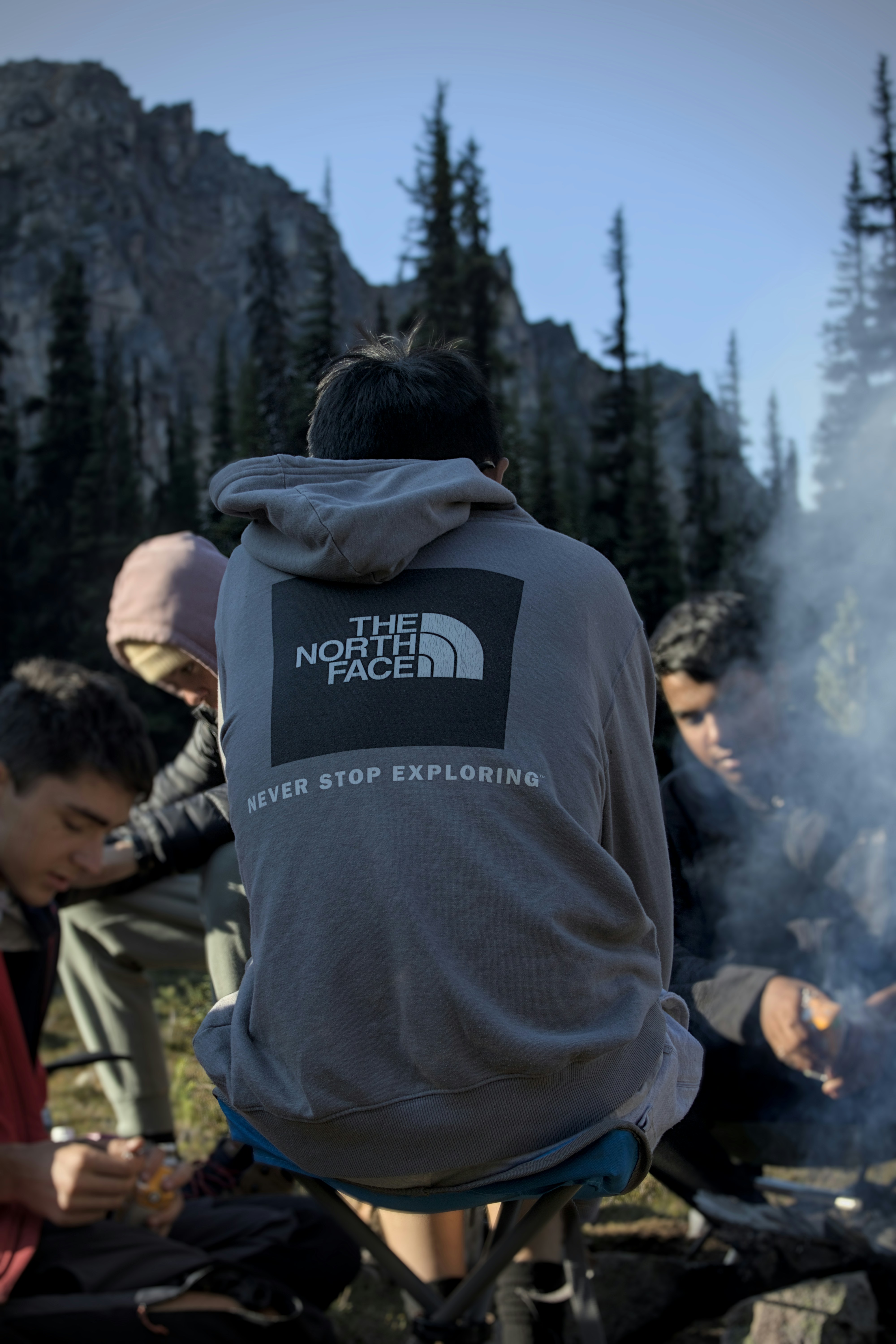 A group of people sitting around a campfire