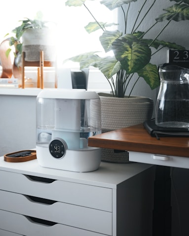 A coffee maker sitting on top of a white dresser