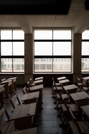 An empty classroom with desks and windows