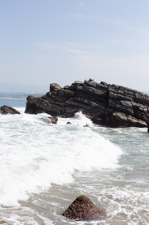 A rocky beach with waves crashing against the rocks