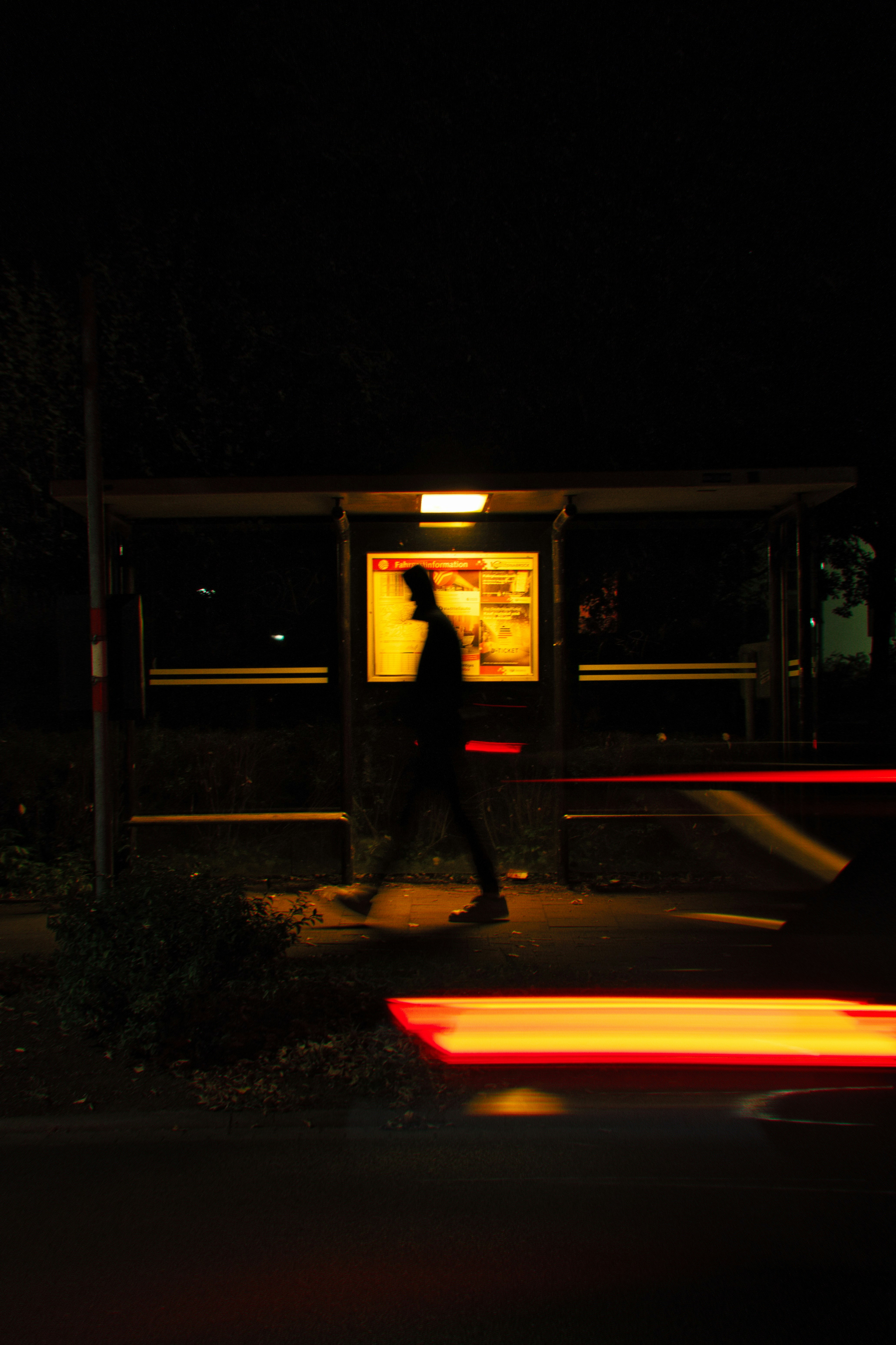 A man walking down a street at night