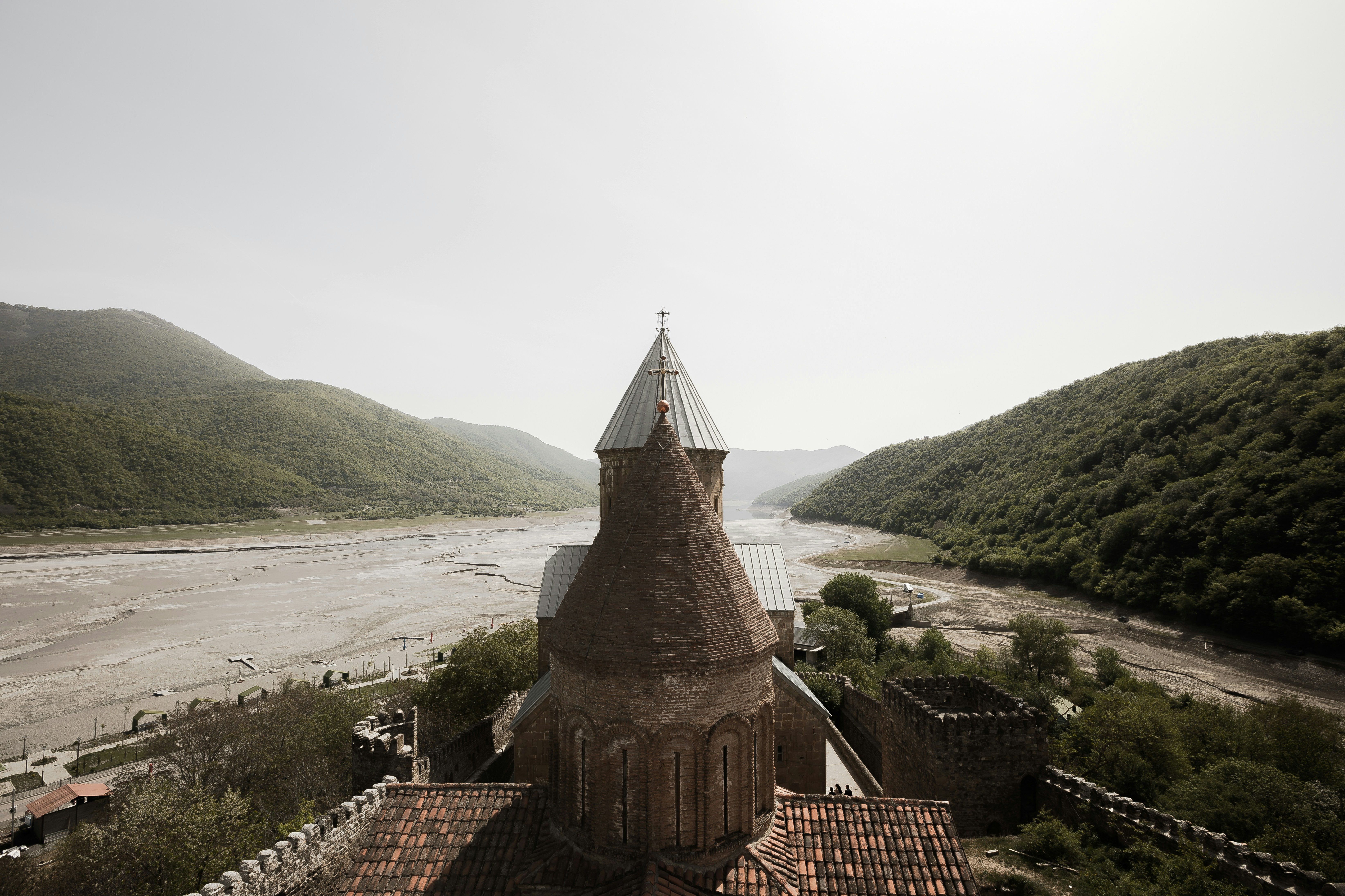 An aerial view of a building with a river in the background photo