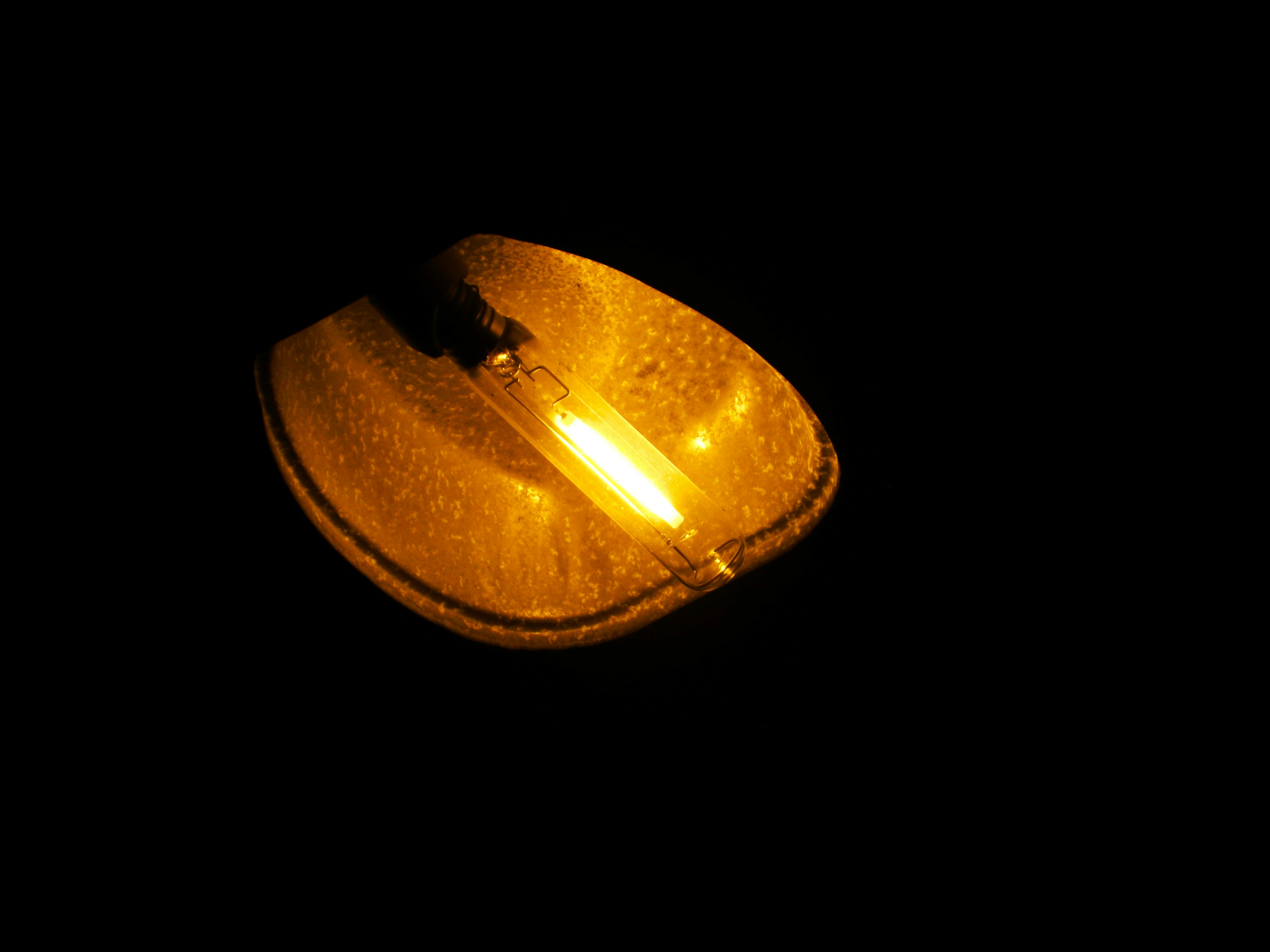 A close up of a yellow object in the dark