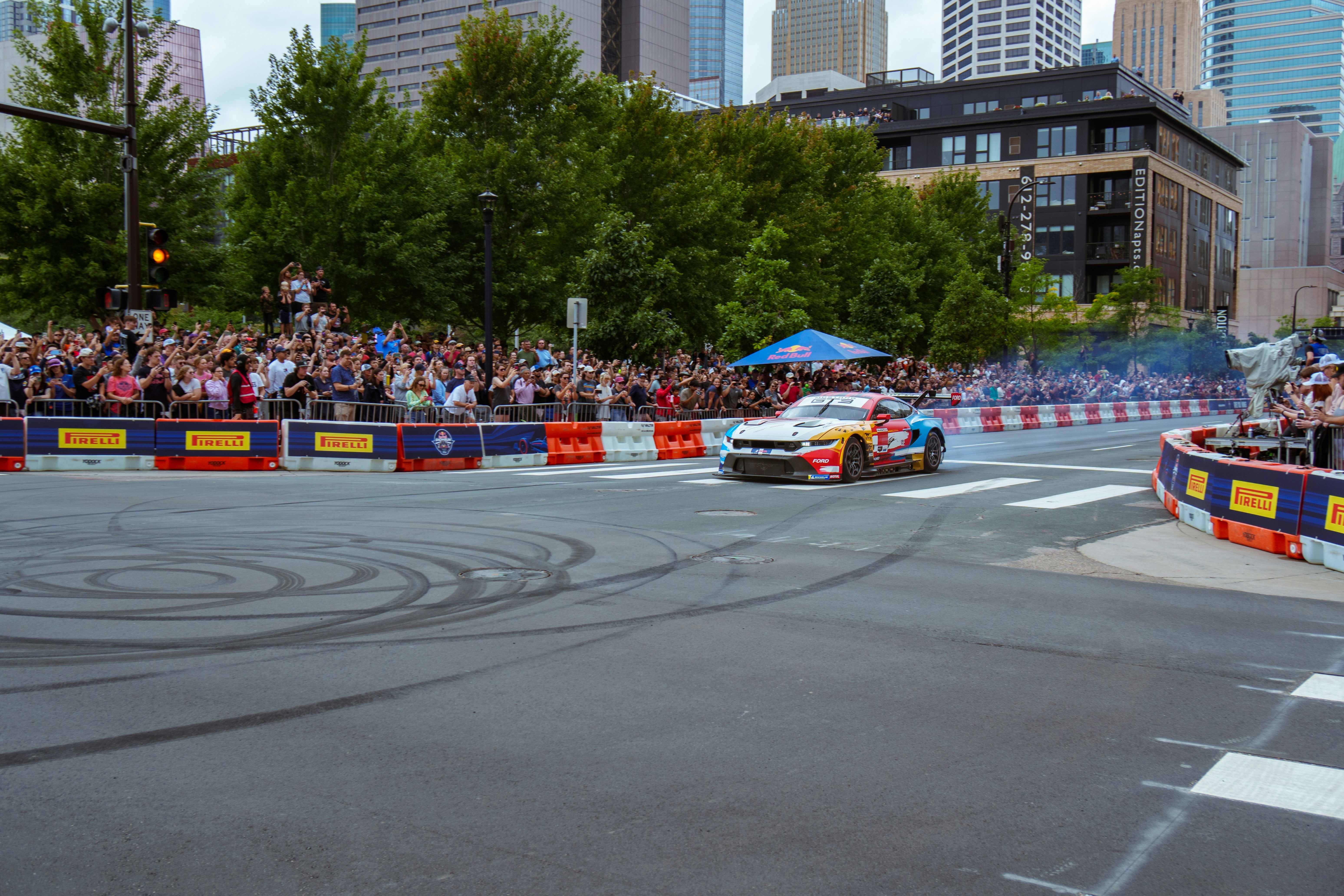 A group of people watching a race on a city street