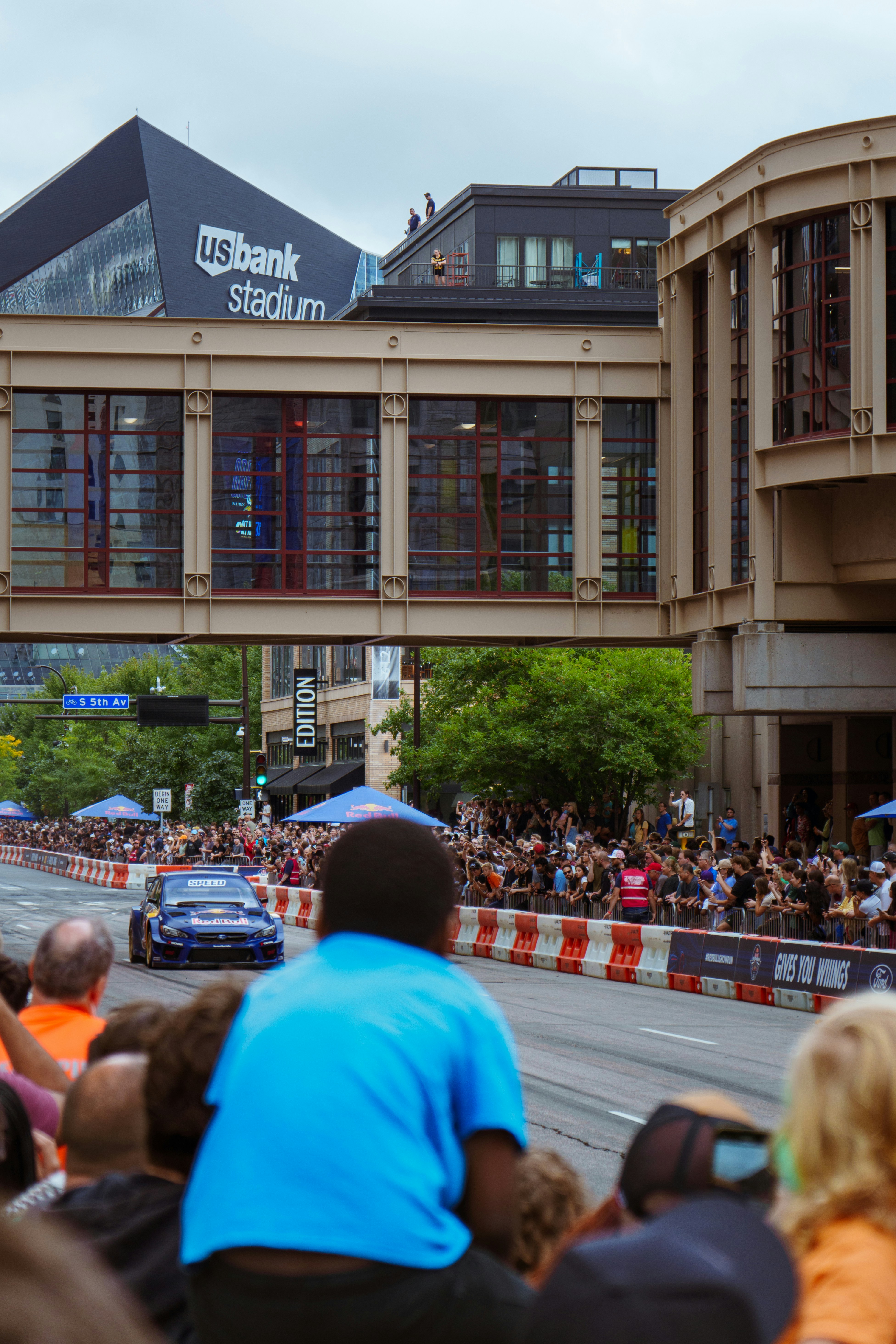 A crowd of people watching a race on a street