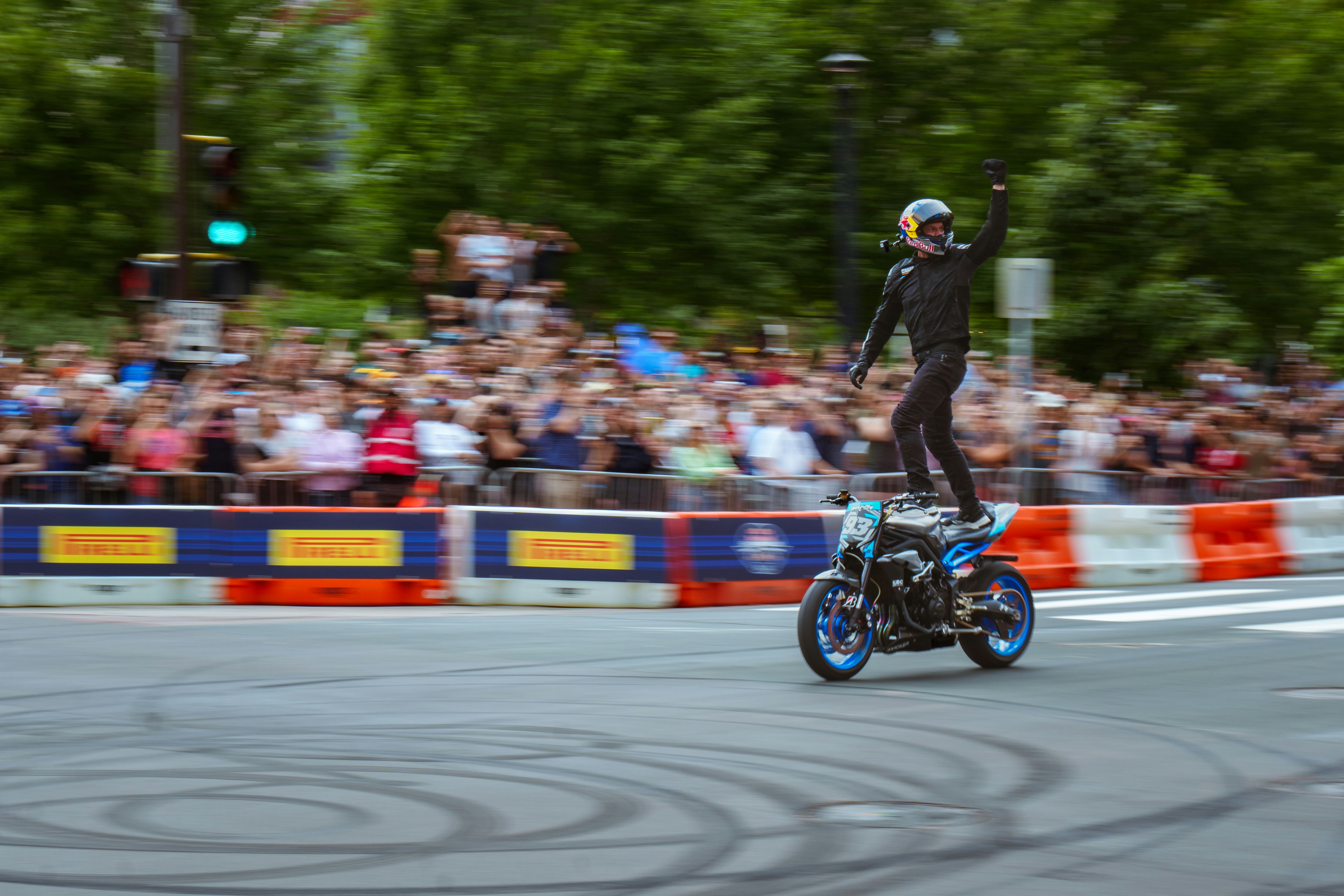 A man riding a motorcycle on top of a street
