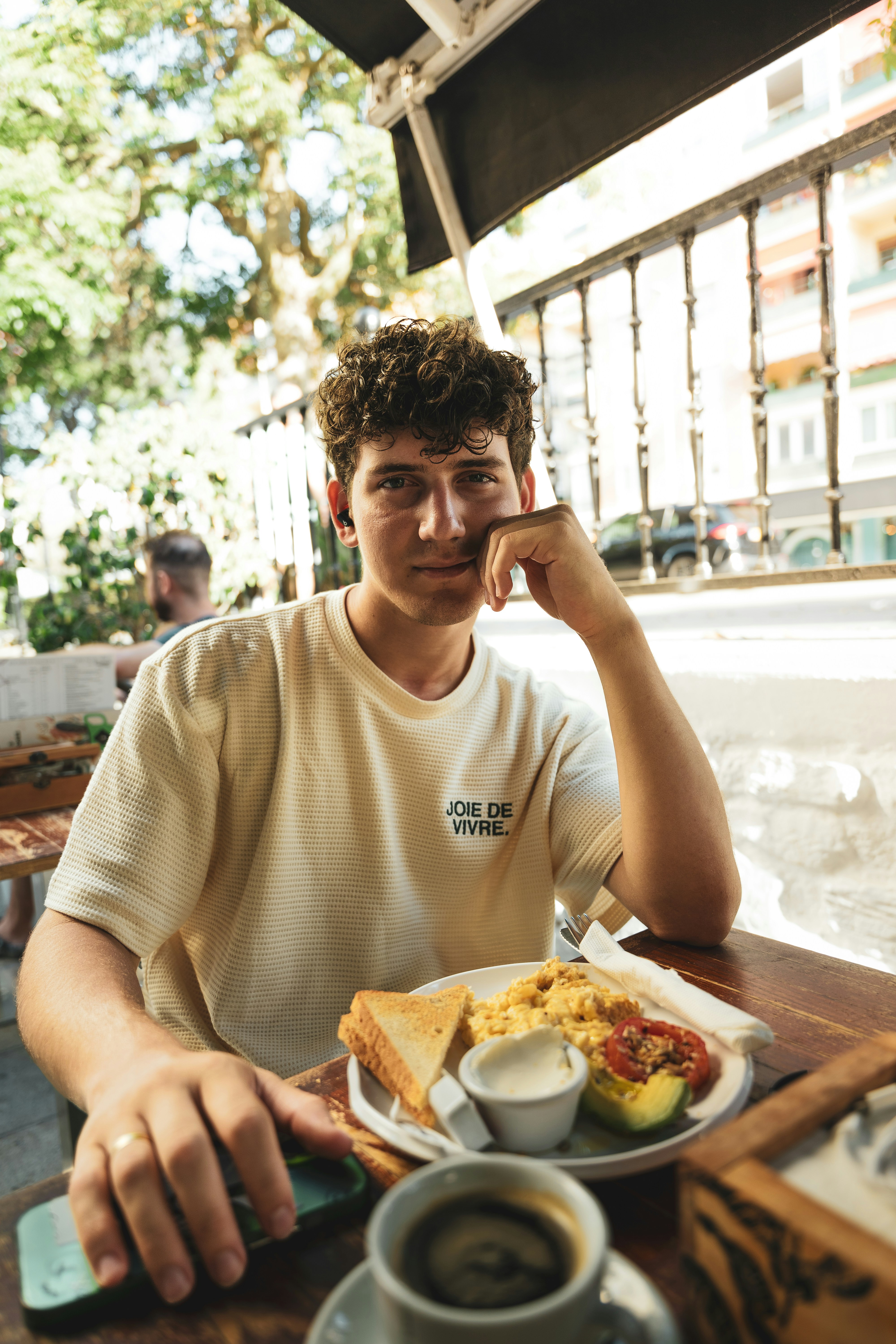 A man sitting at a table with a plate of food
