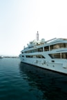 A large white boat floating on top of a body of water
