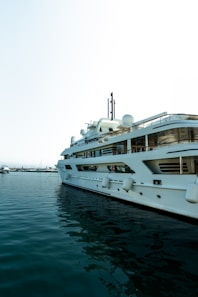 A large white boat floating on top of a body of water