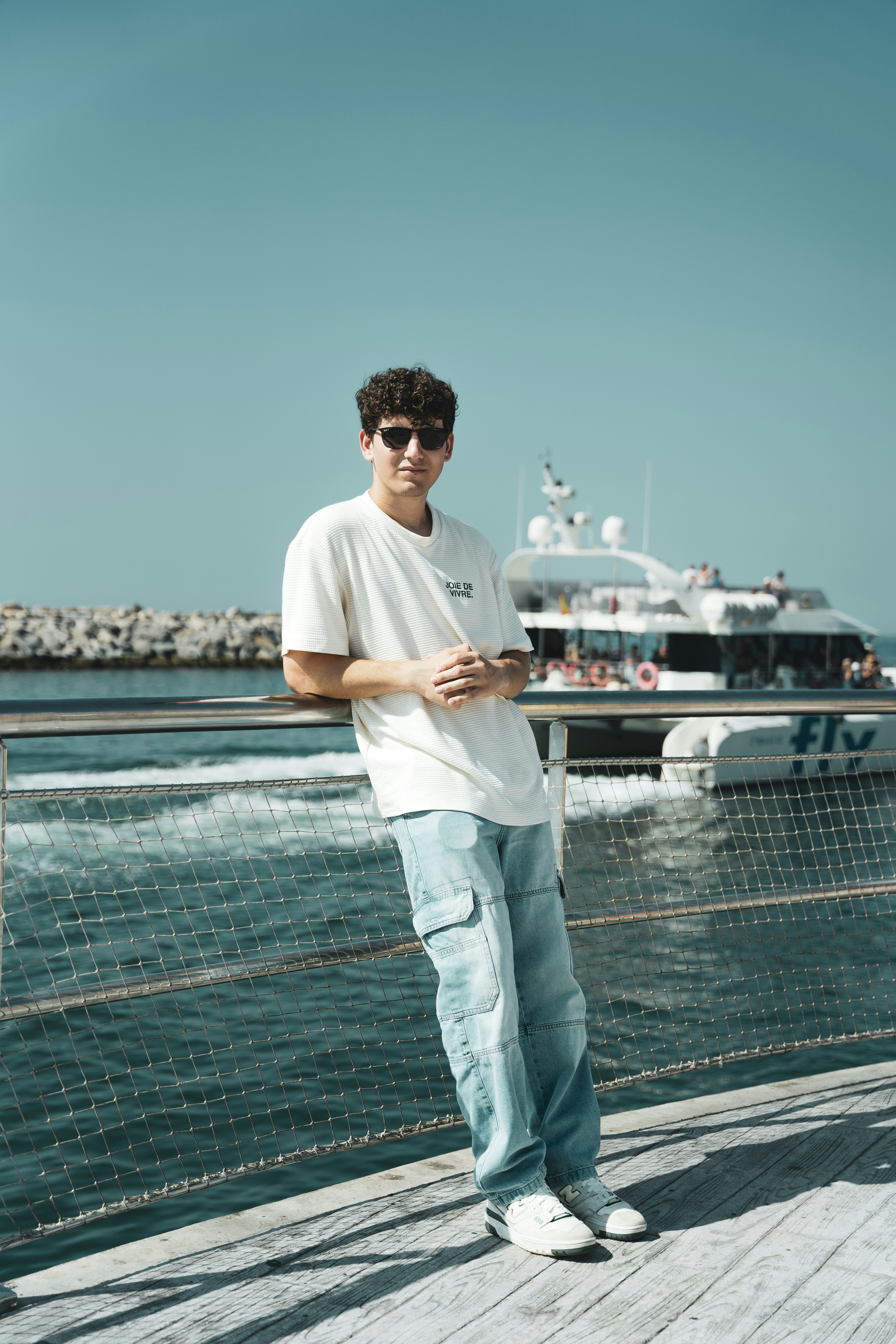 A man standing on a dock next to a boat