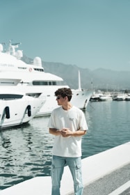 A man standing on a dock next to a boat