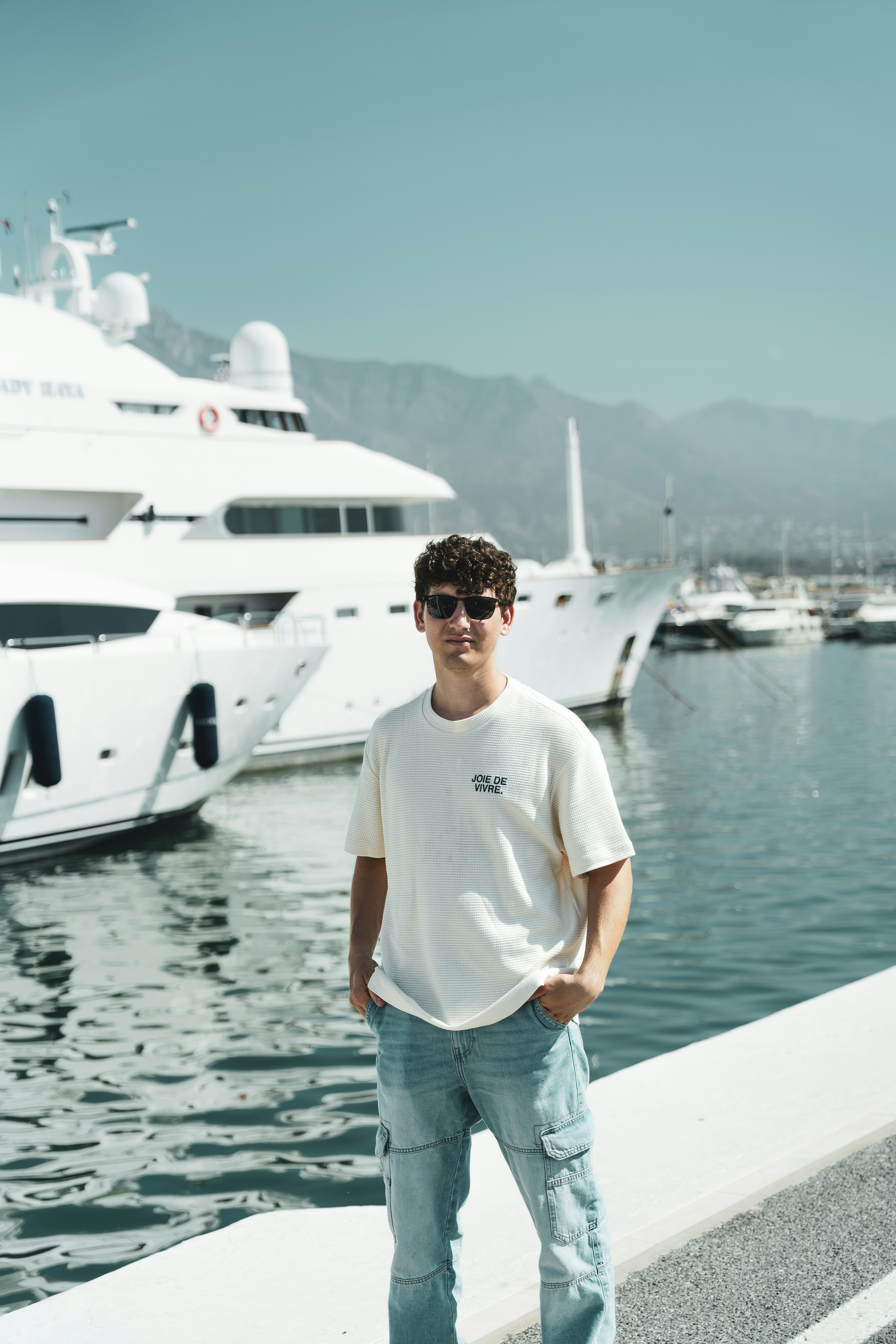 A man standing in front of a large white boat