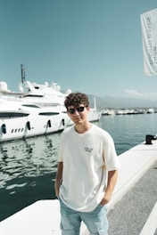 A man standing on a dock next to a boat
