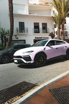 A pink car parked on the side of the road