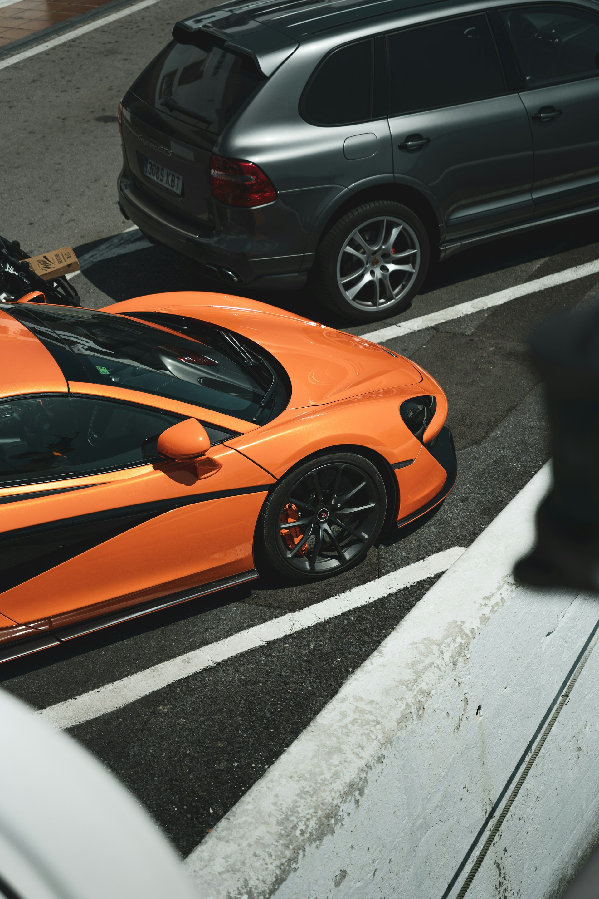 An orange sports car parked on the side of the road