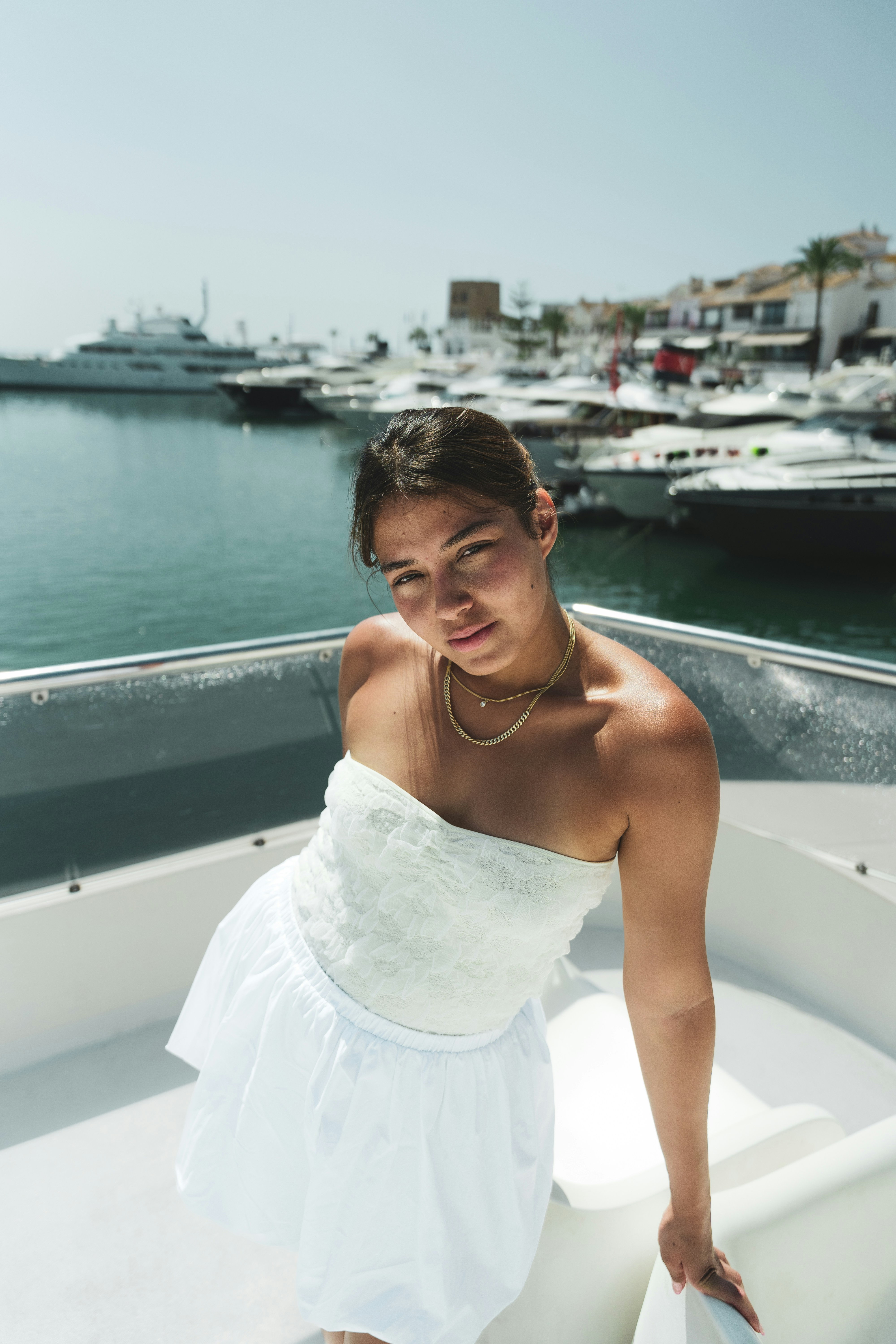 A woman in a white dress on a boat