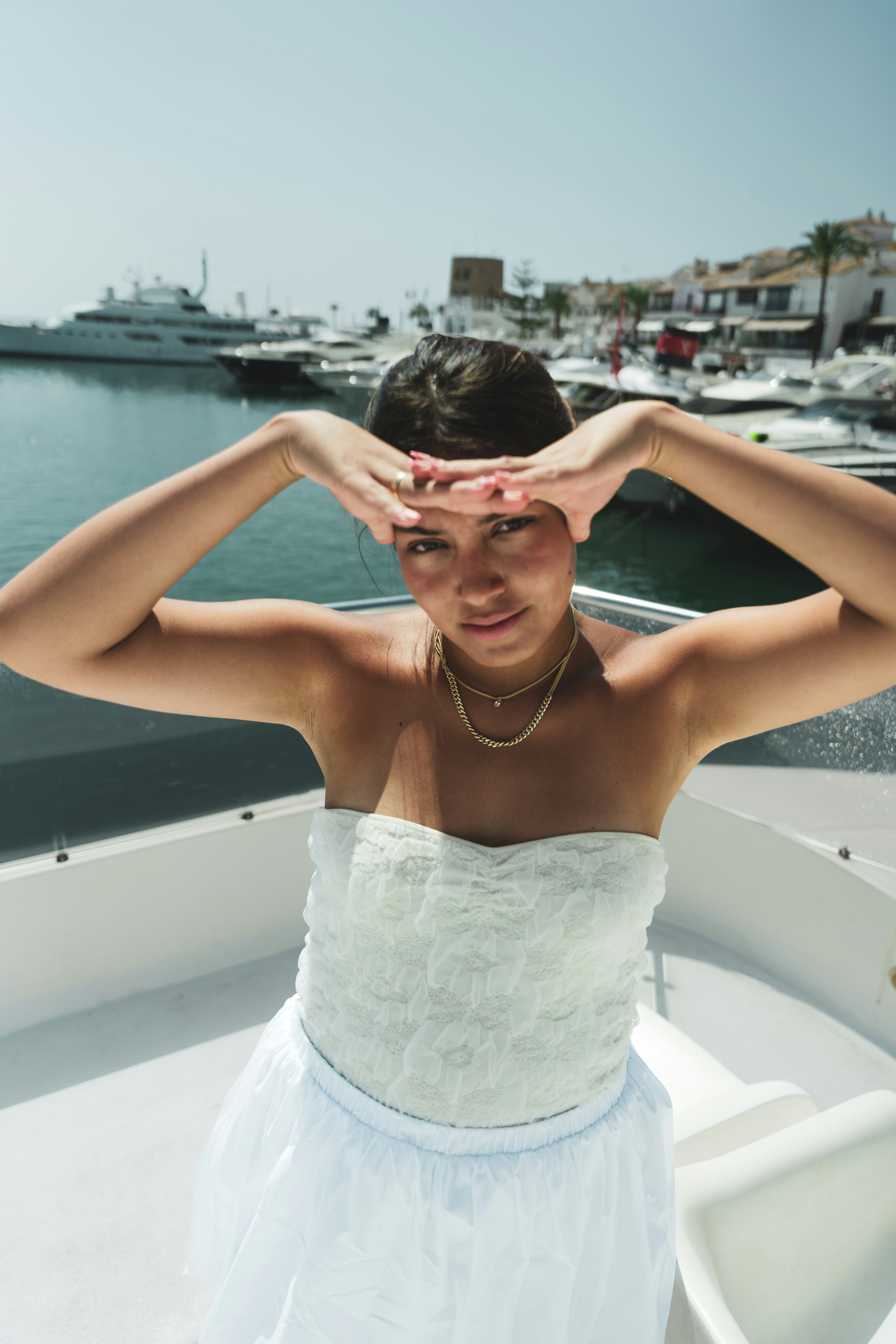 A woman in a white dress on a boat