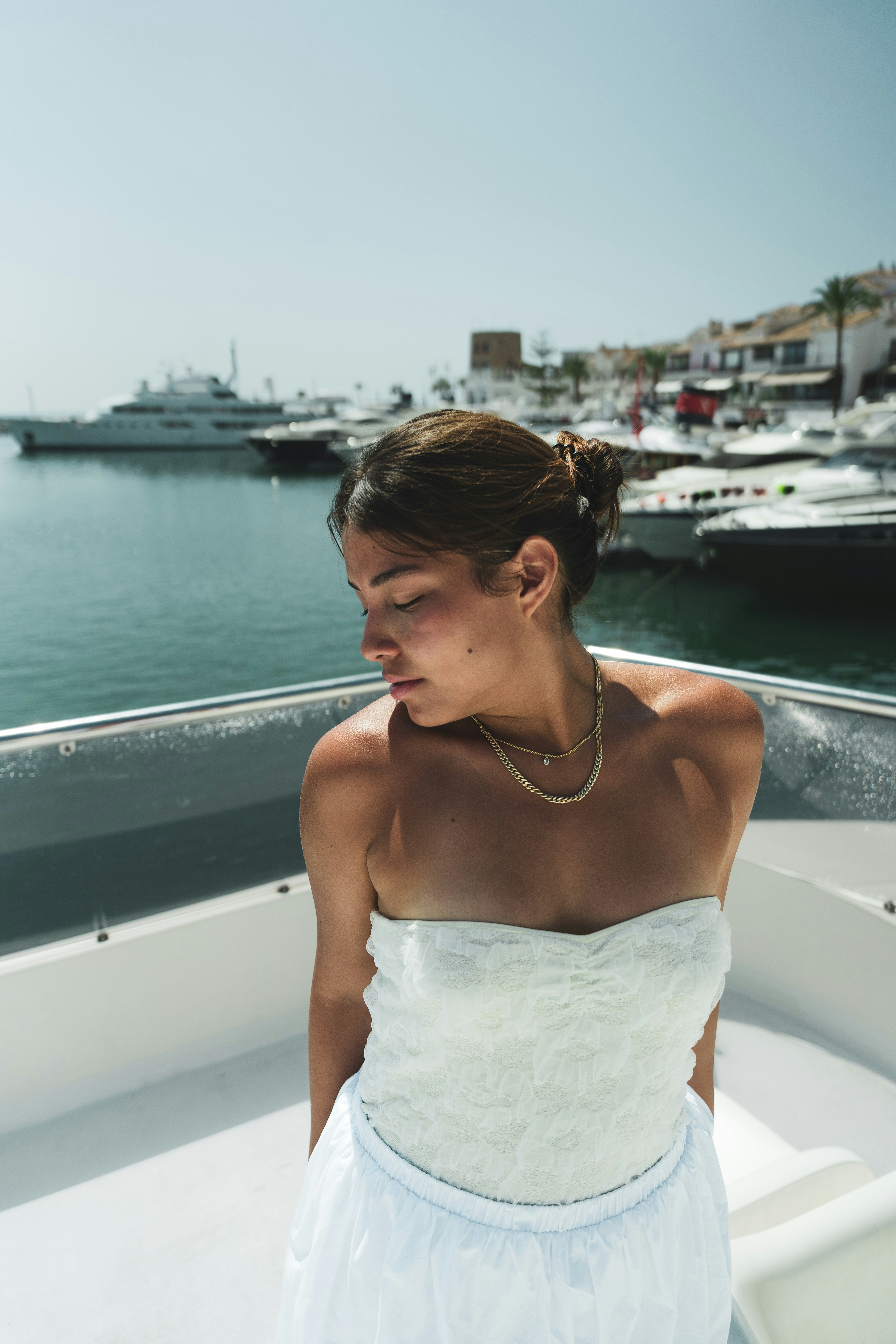 A woman in a white dress on a boat