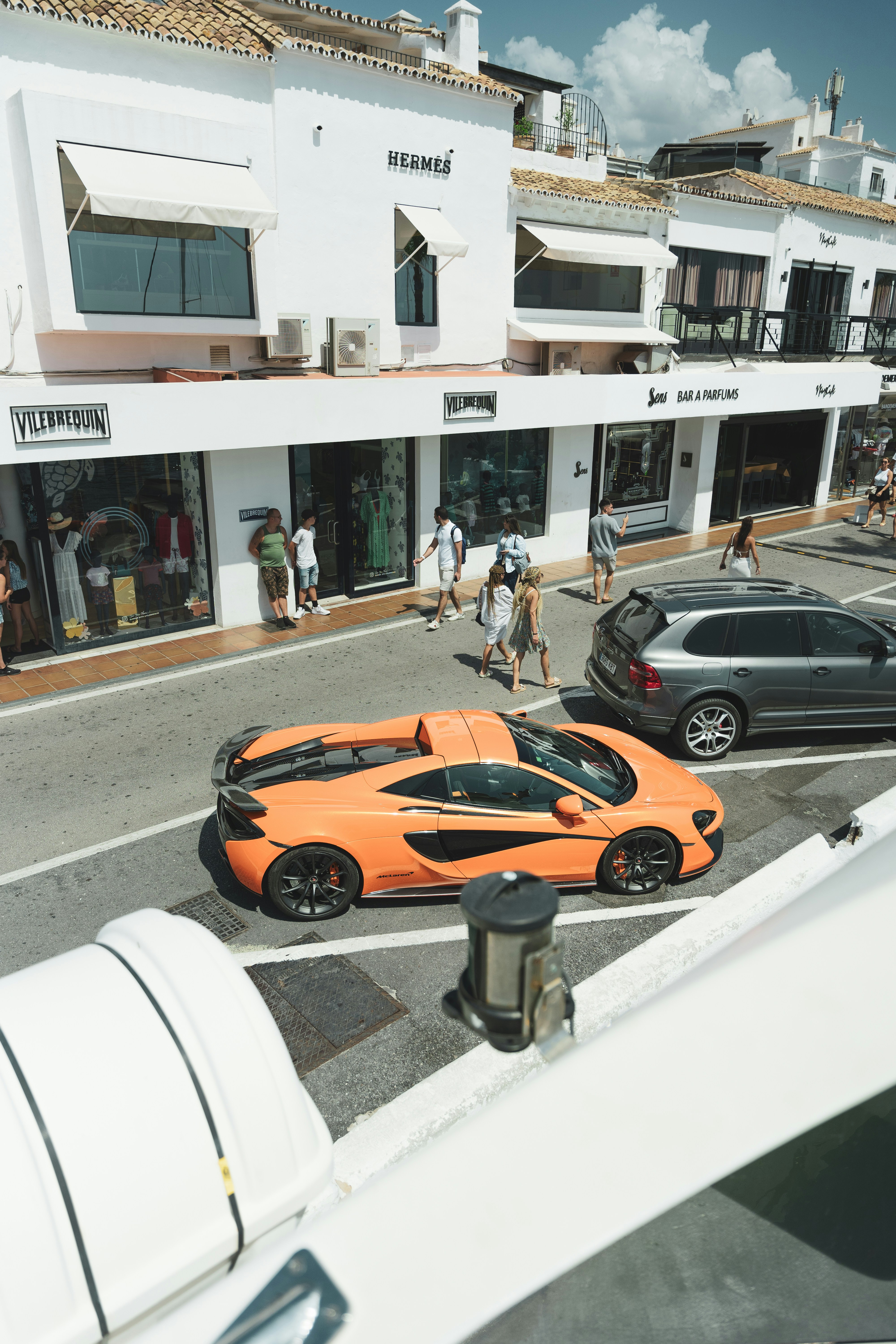 A group of cars parked on the side of a road