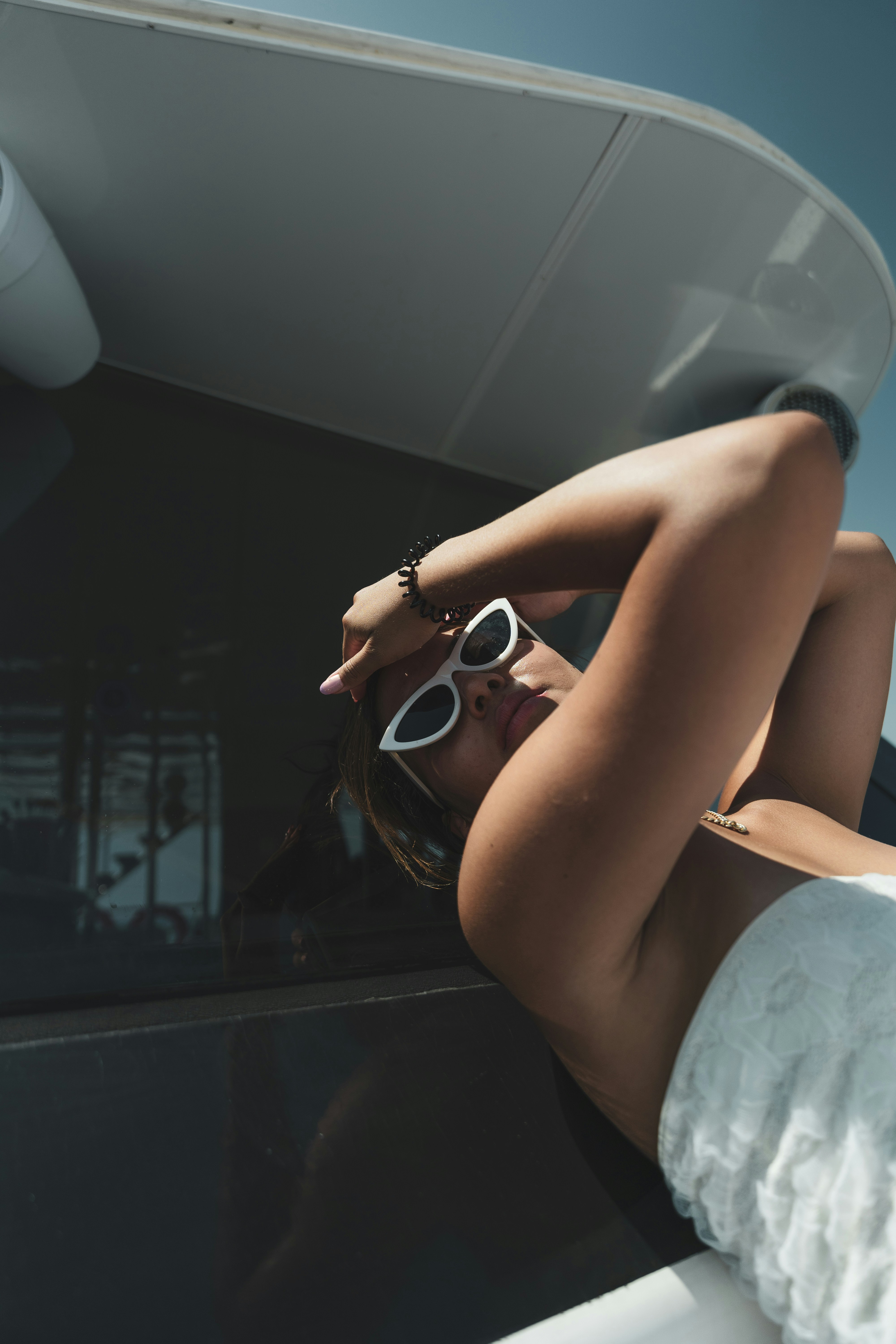 A woman in a bikini laying on a boat