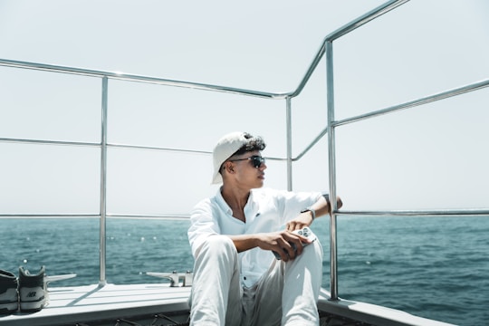 A man sitting on a boat in the water