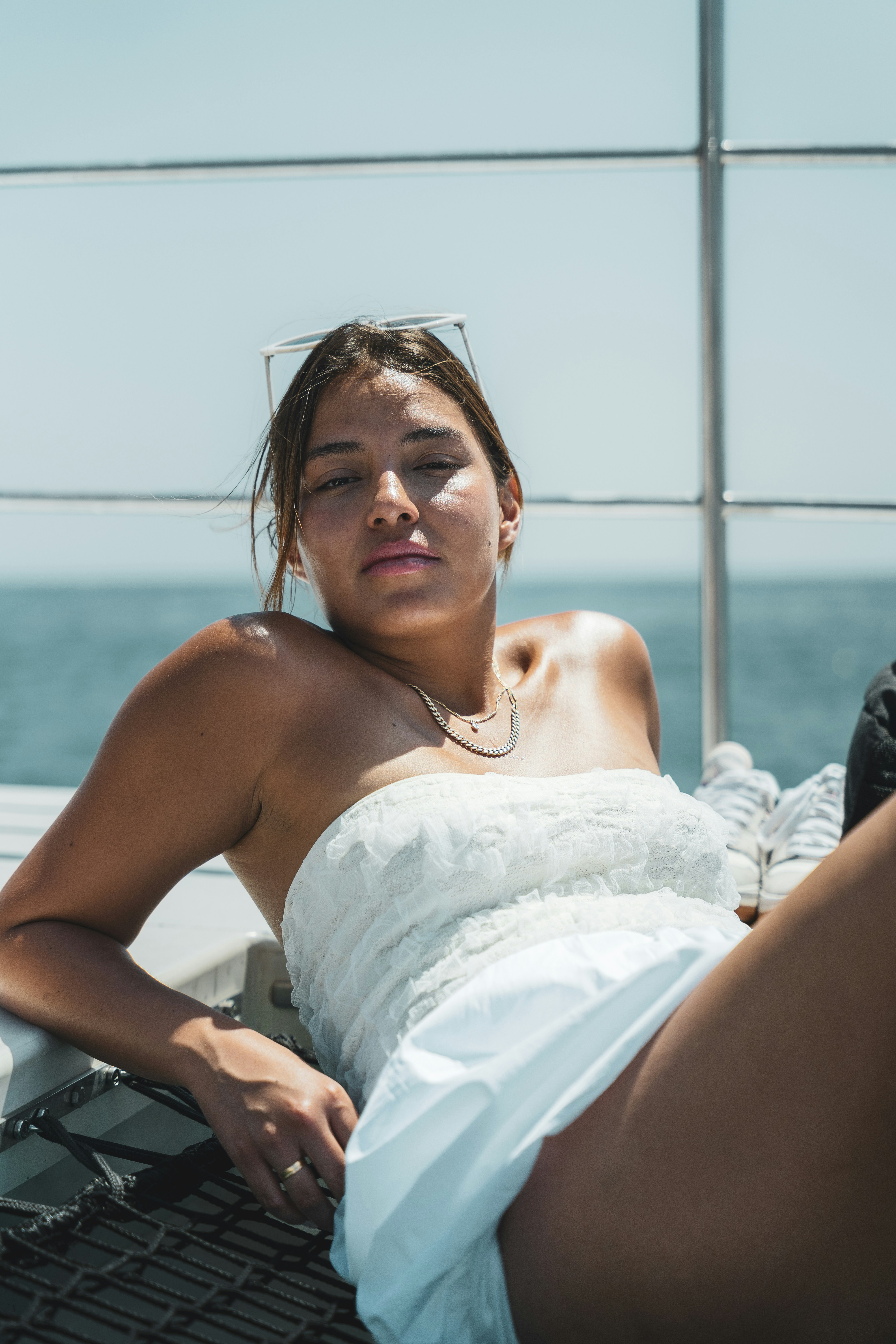 A woman in a white dress laying on a boat
