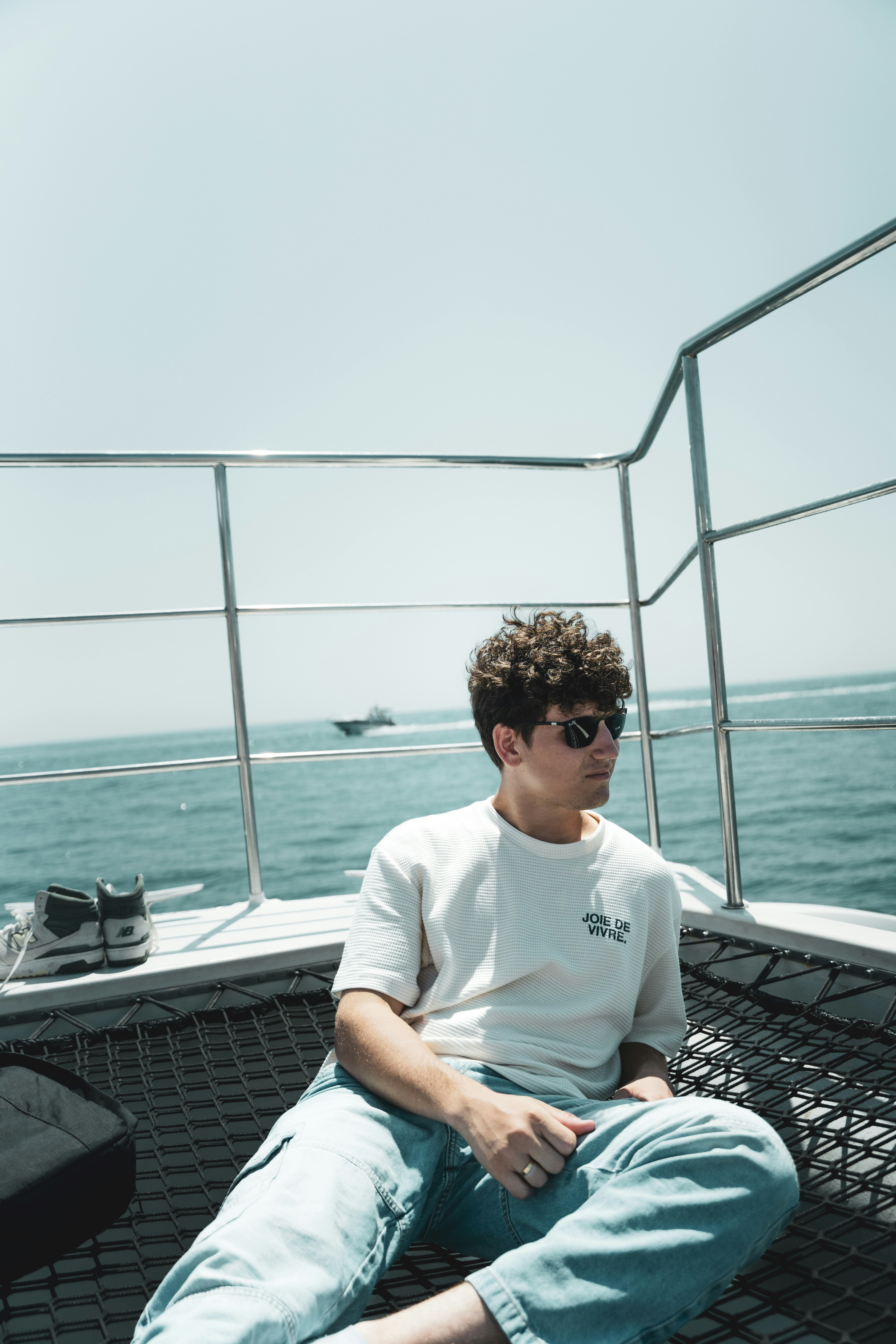 A man sitting on the back of a boat