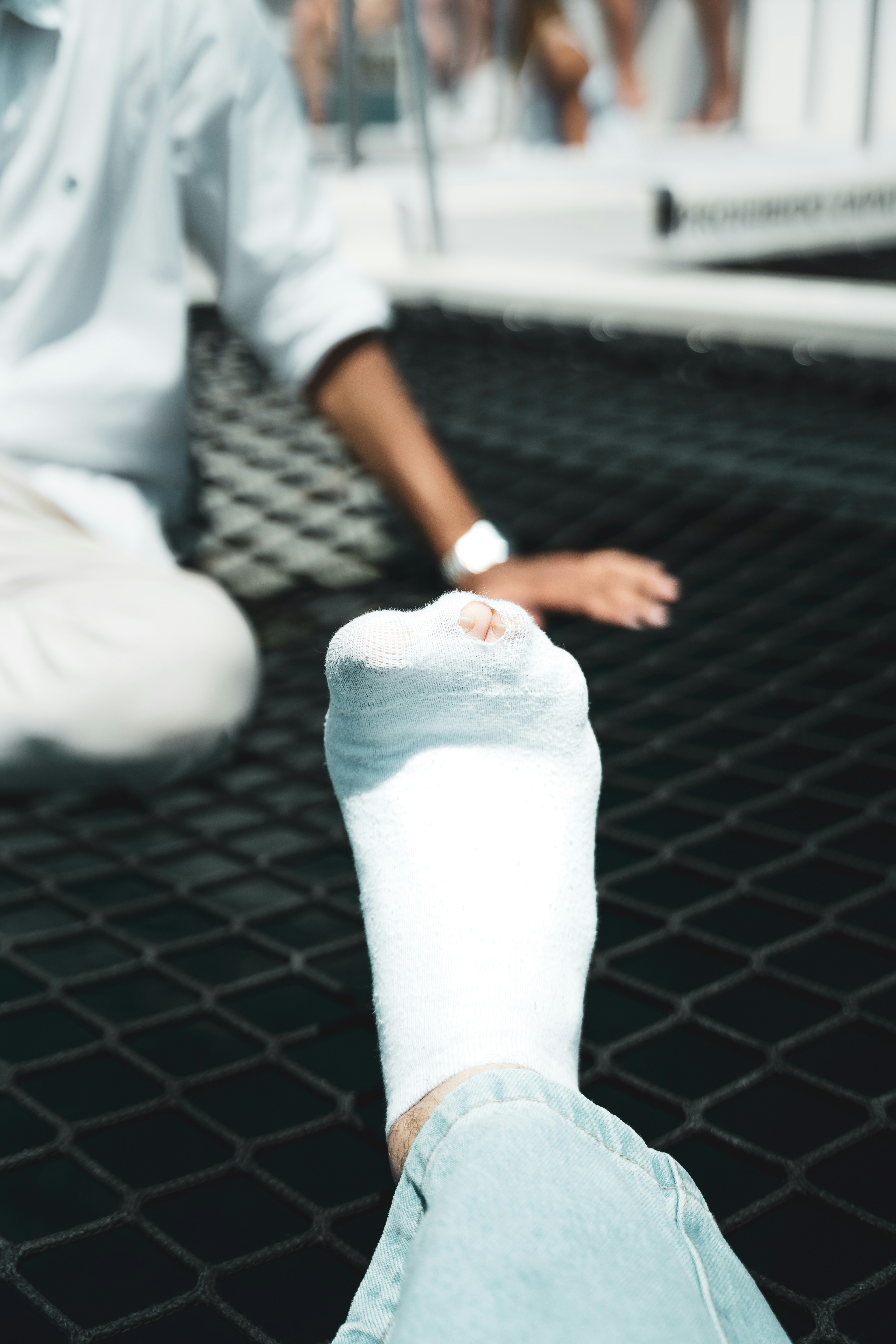 A man sitting on the ground with his foot in the air