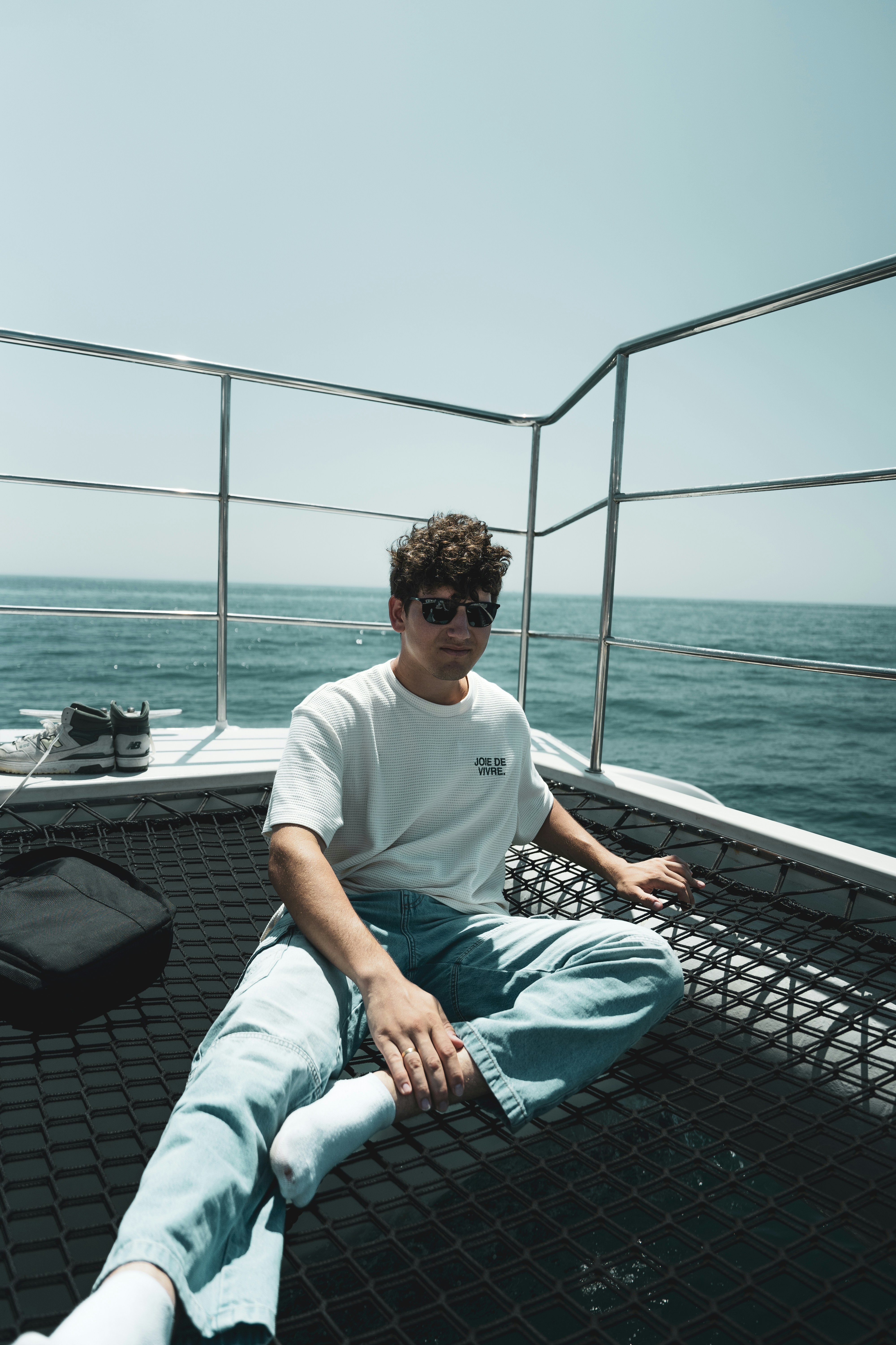 A man sitting on a boat in the ocean