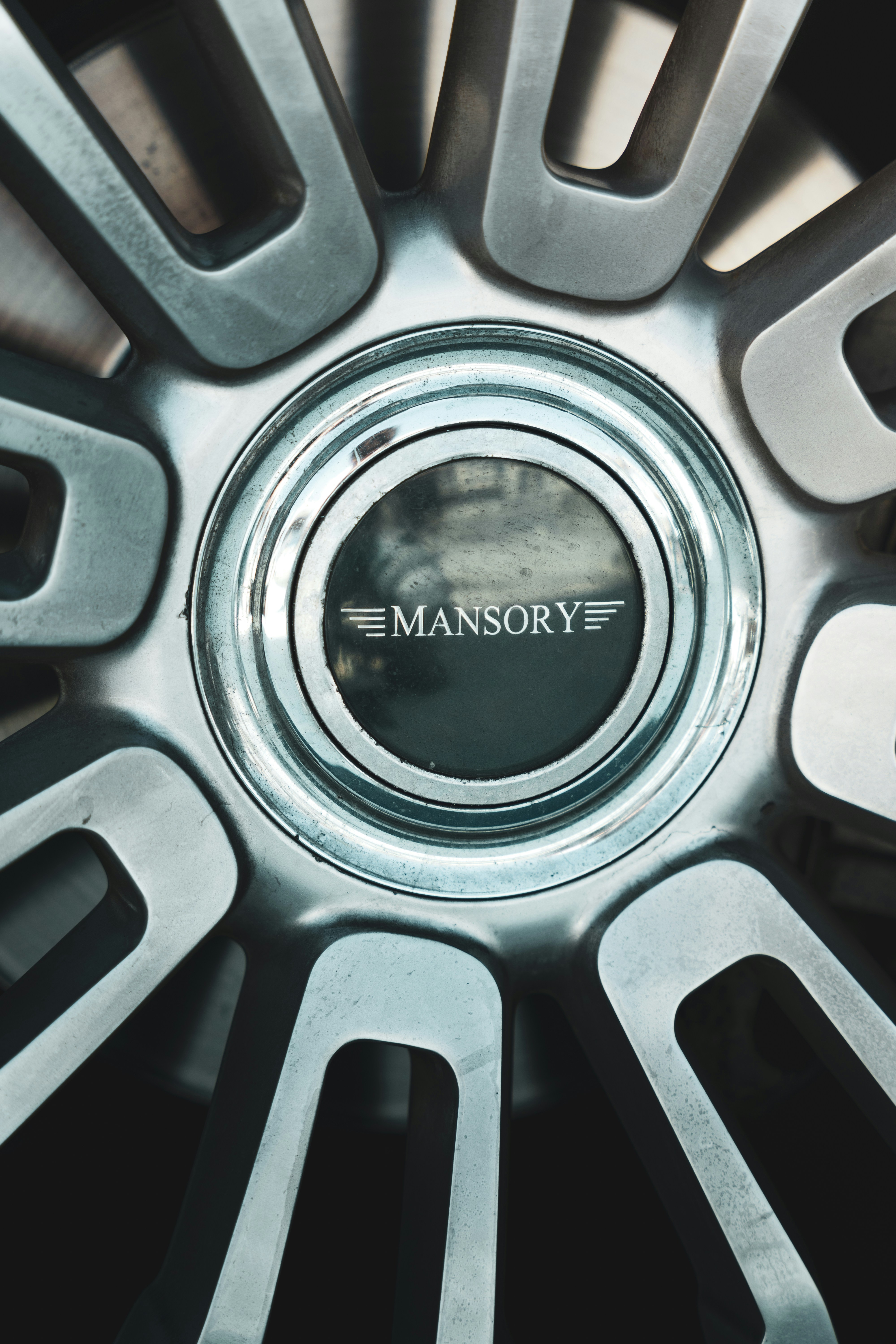 A close up of a metal wheel with a logo on it