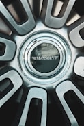 A close up of a metal wheel with a logo on it