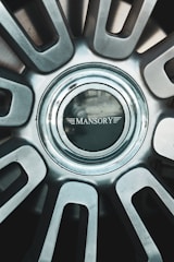 A close up of a metal wheel with a logo on it