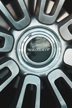 A close up of a metal wheel with a logo on it