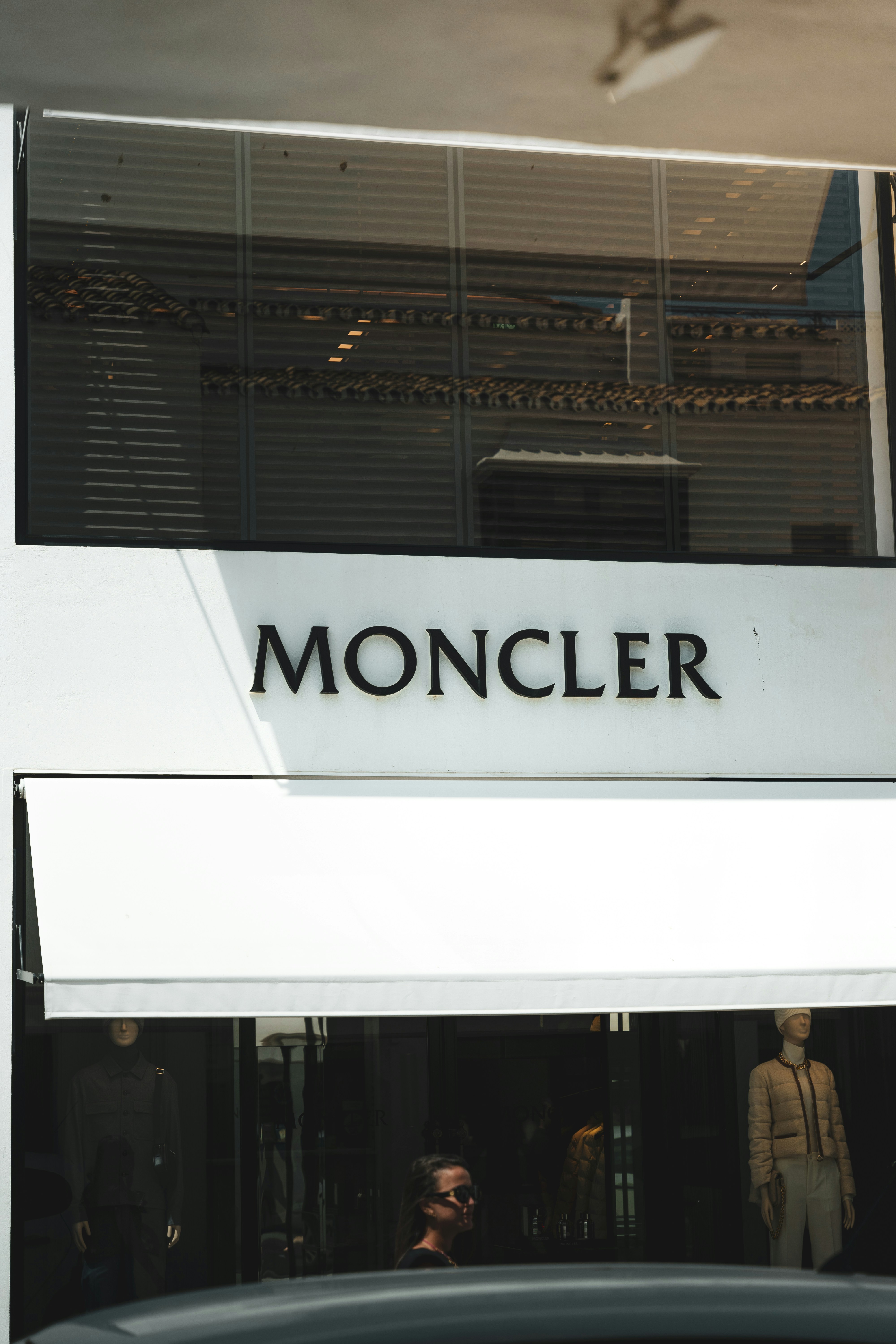 A car parked in front of a store front