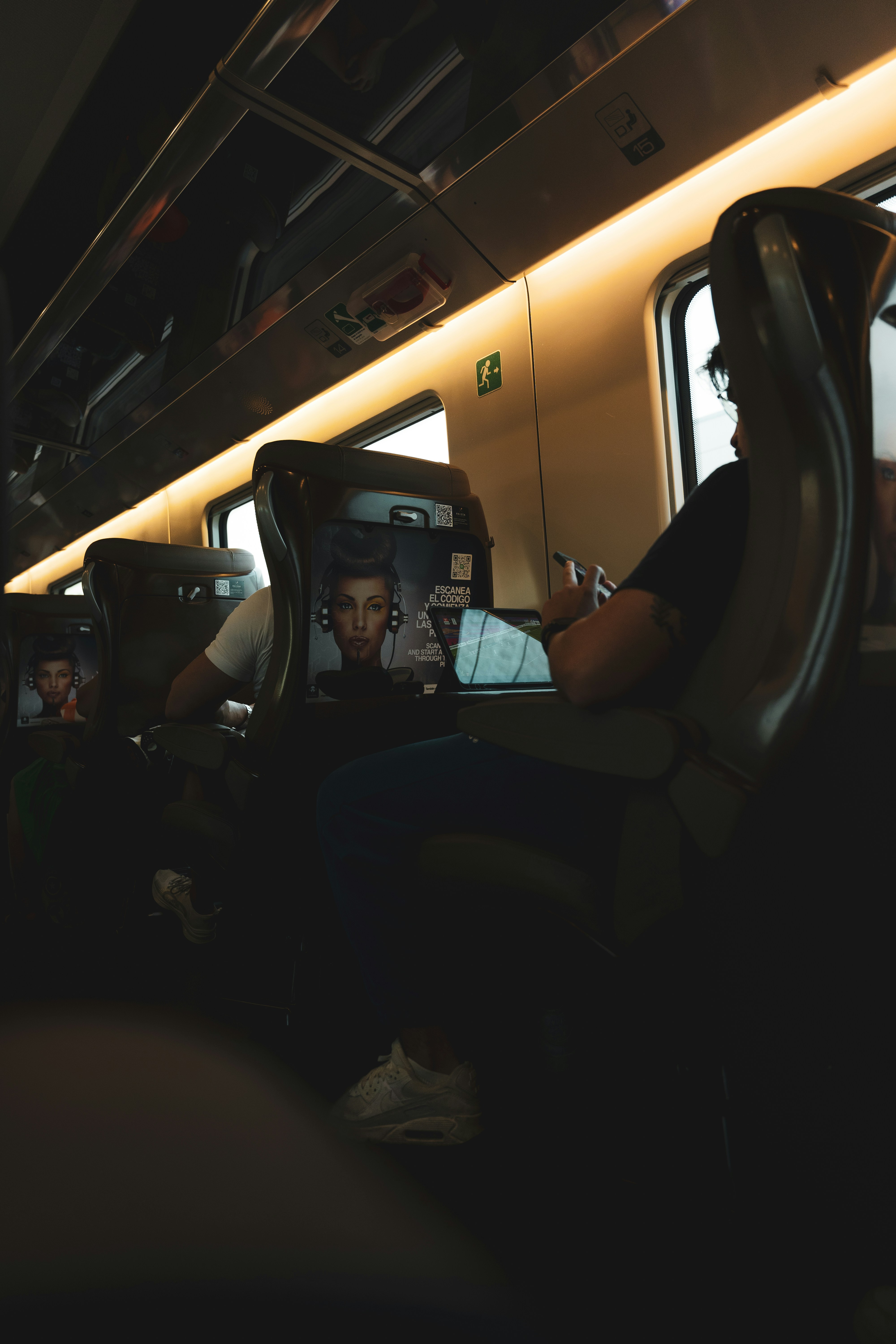 A group of people sitting on a bus at night
