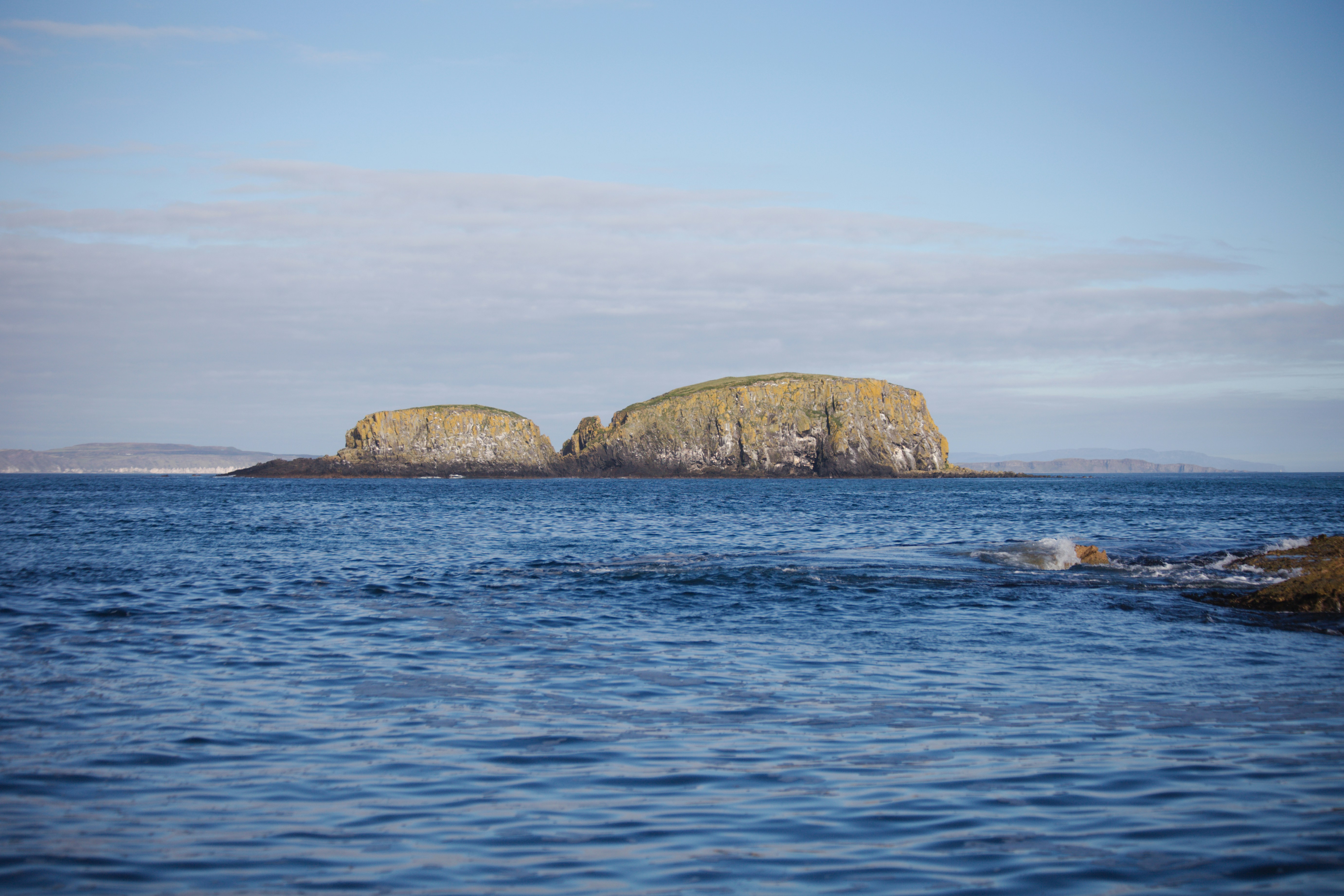A body of water with a small island in the middle of it