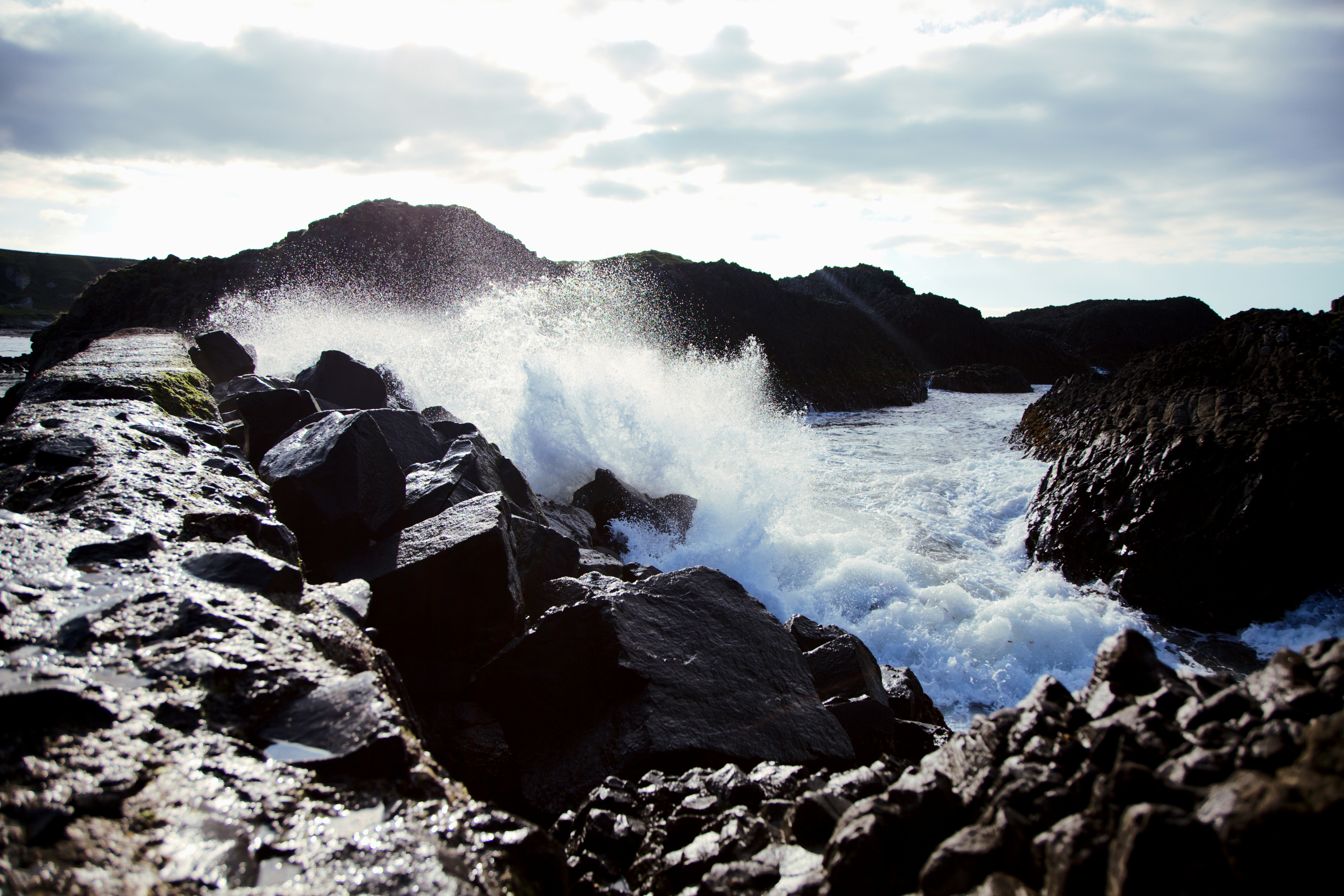 A rocky shore with waves crashing against the rocks