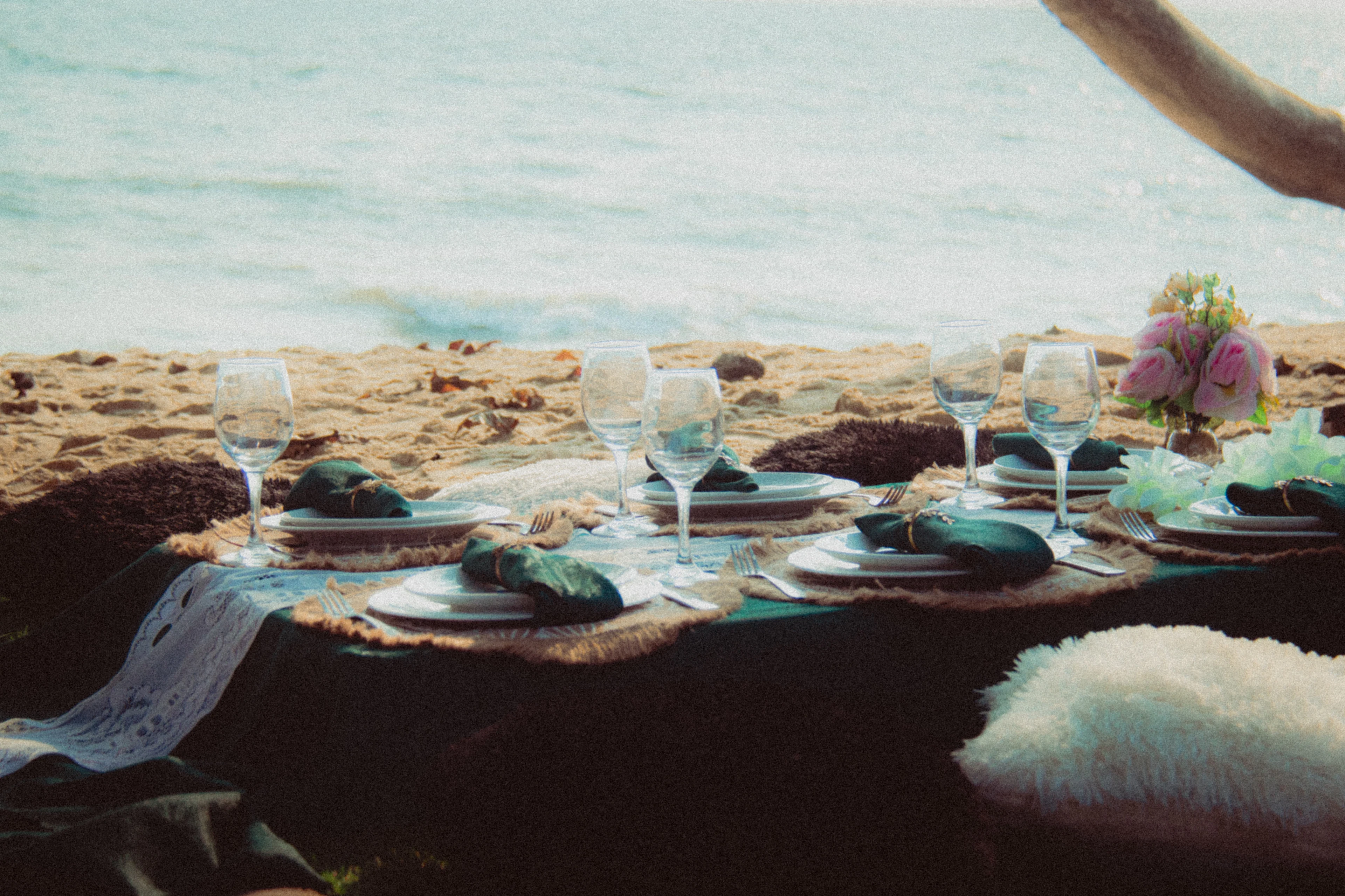 A table laid for dinner on the beach