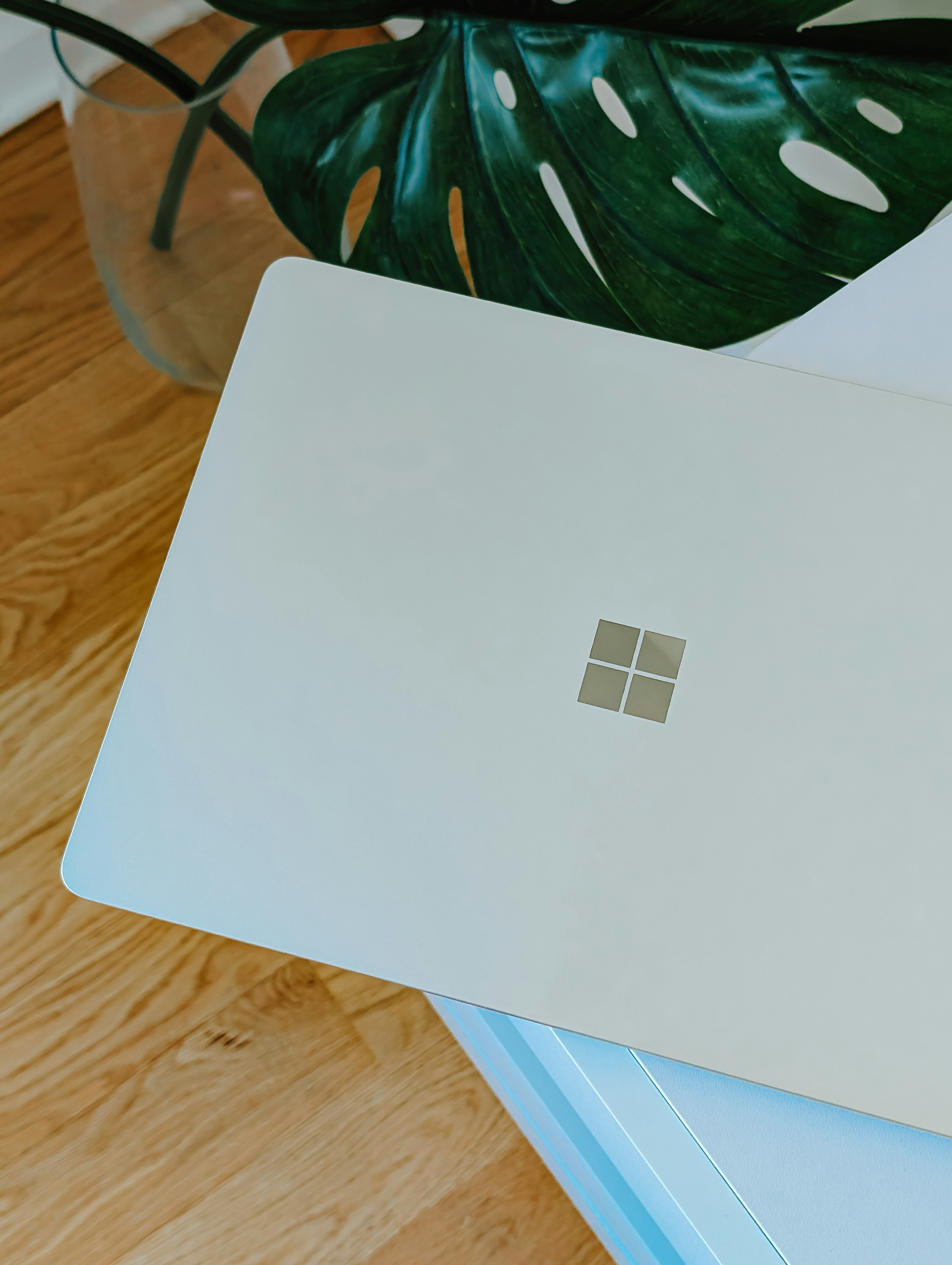 A laptop computer sitting on top of a wooden table