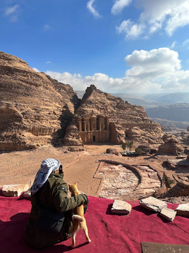 A person sitting on top of a red blanket