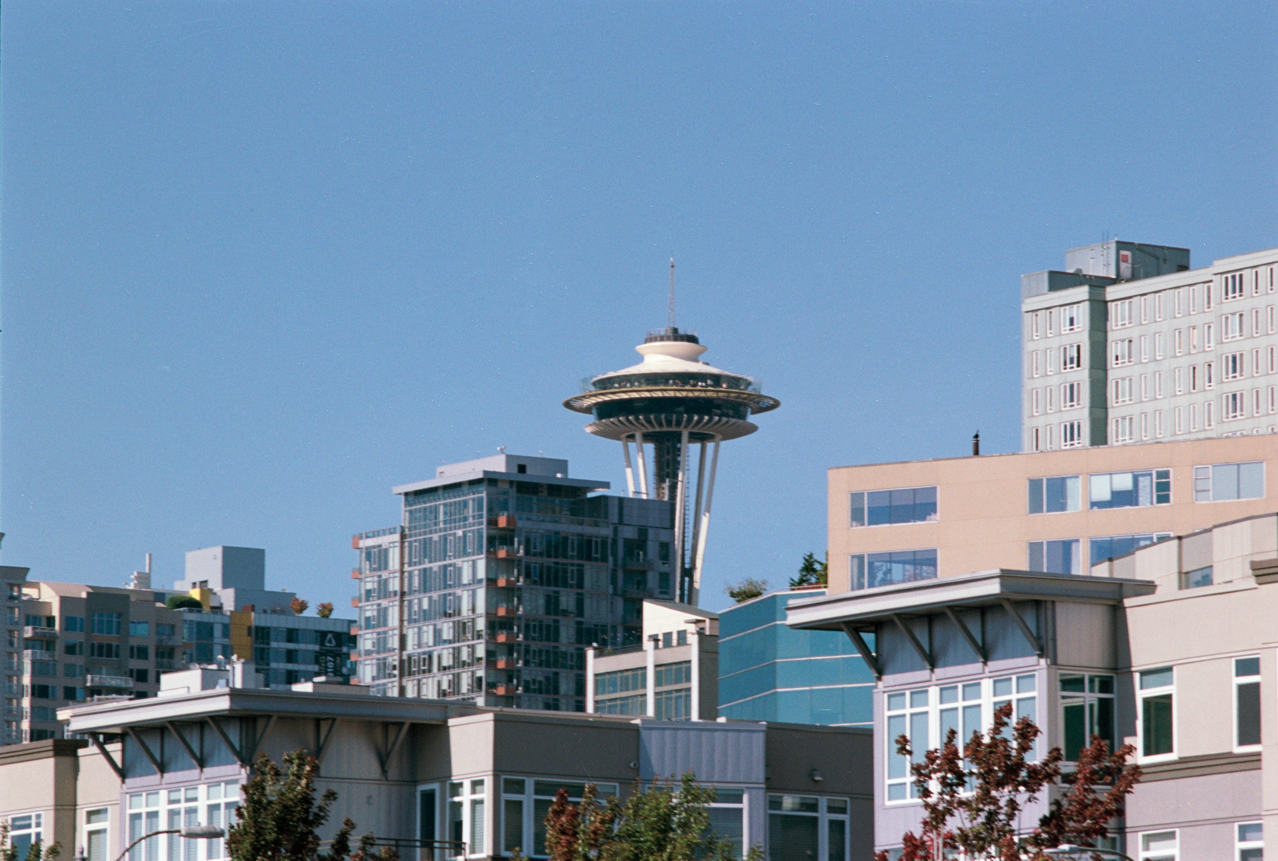 A view of a city with a space needle in the background