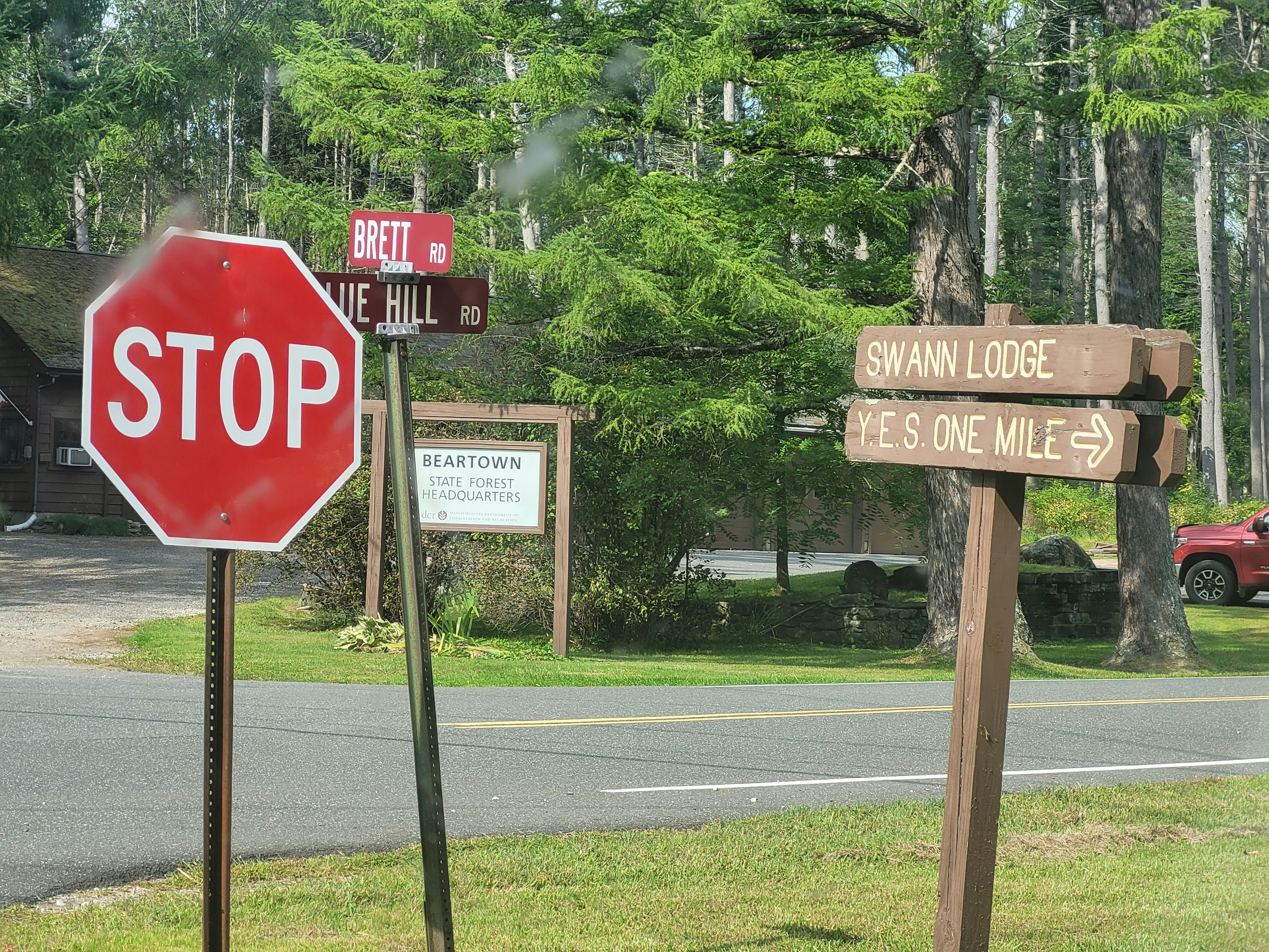 A red stop sign sitting on the side of a road