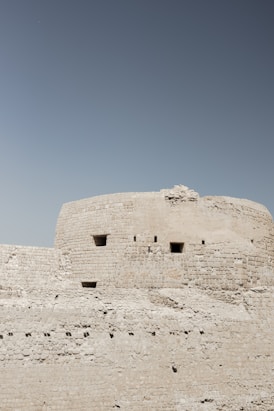 A large stone structure with a sky background