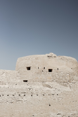 A large stone structure with a sky background